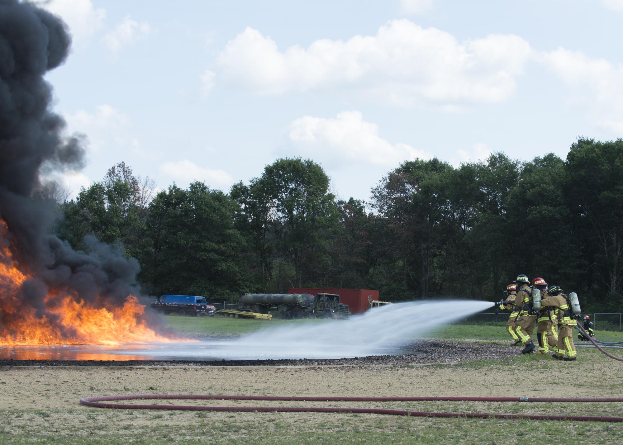 Air Force Reserve firefighters extinguish a fuel fire during exercise Patriot Warrior, Aug. 18, 2016, Sparta/Fort McCoy Airport, Wis. Patriot Warrior allows Air Reserve fire fighting units from throughout the U.S. to train together and learn from professionals throughout the career field in a deployment-style environment. (U.S. Air Force Photo/ Tech. Sgt. Nathan Rivard)