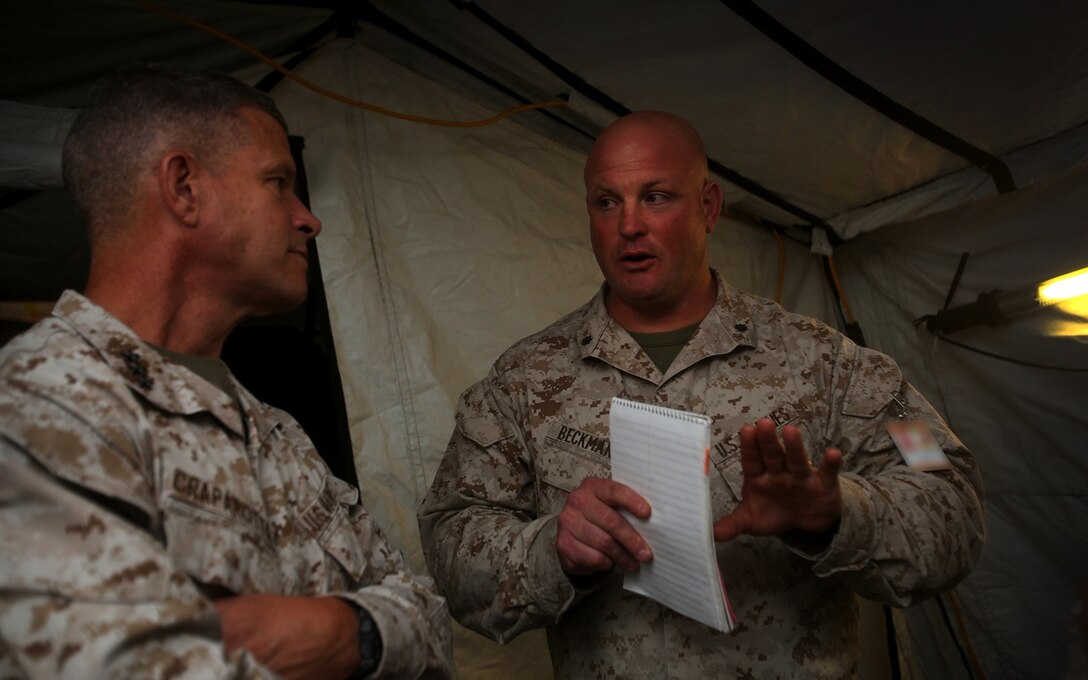 U.S. Marine Lt. Col. Eric Beckmann speaks to Lt. Gen. Lewis A. Craparott during the I Marine Expeditionary Force Large Scale Exercise 16 at Camp Pendleton, Calif., Aug. 19, 2016. Craparotta is the I MEF commanding general and Beckmann is the 1st Marine Logistics Group G-3 assistant chief of staff. LSE 16 tests I MEF’s ability to plan, deploy, and command and control a force of more than 50,000 Marines and Sailors against a near-peer enemy force. The exercise tests 1st MLG’s ability to provide sufficient, agile, flexible and responsive tactical level logistics to I MEF forces in support of operations. (U.S. Marine Corps photo illustration by Sgt. Laura Gauna/ released)