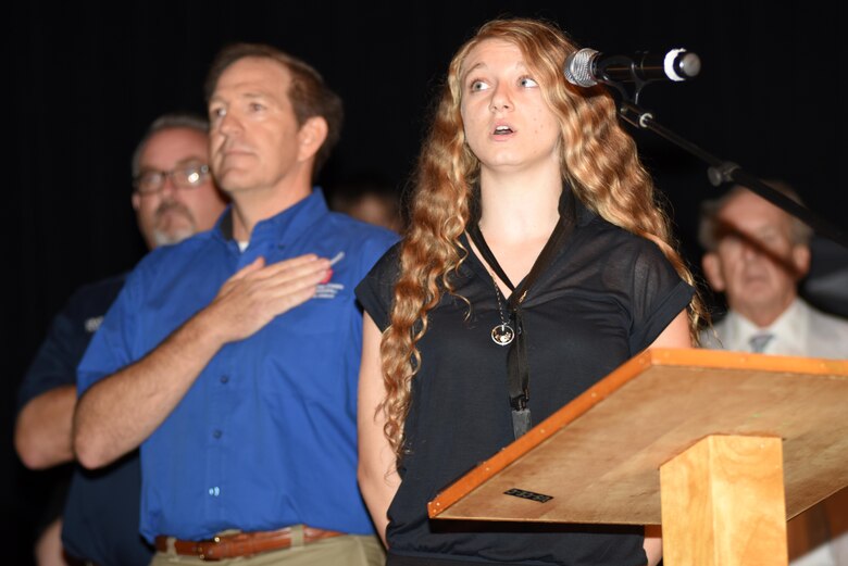 Cierra Henry performs the National Anthem during the 50th anniversary of Barkley Dam at the Badgett Playhouse Theater in Grand Rivers, Ky., Aug. 20, 2016. 