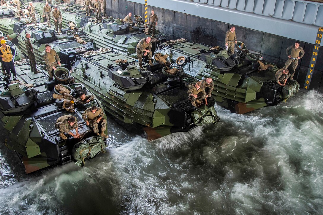 Marines secure amphibious assault vehicles in the well deck of the amphibious dock landing ship USS Germantown near Okinawa, Japan, Aug. 21, 2016. The Germantown is supporting security and stability in the Indo-Asia-Pacific region. Navy photo by Petty Officer 2nd Class Raymond D. Diaz III
