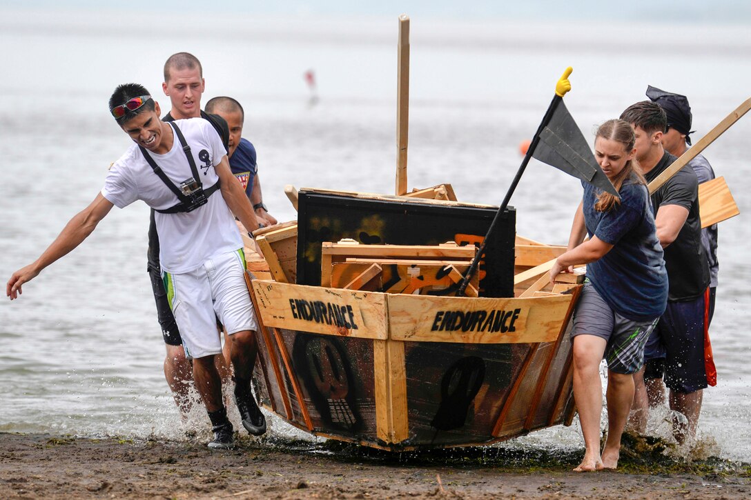 Sailors  haul a homemade boat onto the beach during an annual boat regatta in Misawa, Japan, Aug. 19, 2016. Eight teams from the Navy and Air Force competed this year. The sailors are assigned to Naval Air Facility Misawa. Navy Photo by Petty Officer 2nd Class Samuel Weldin
