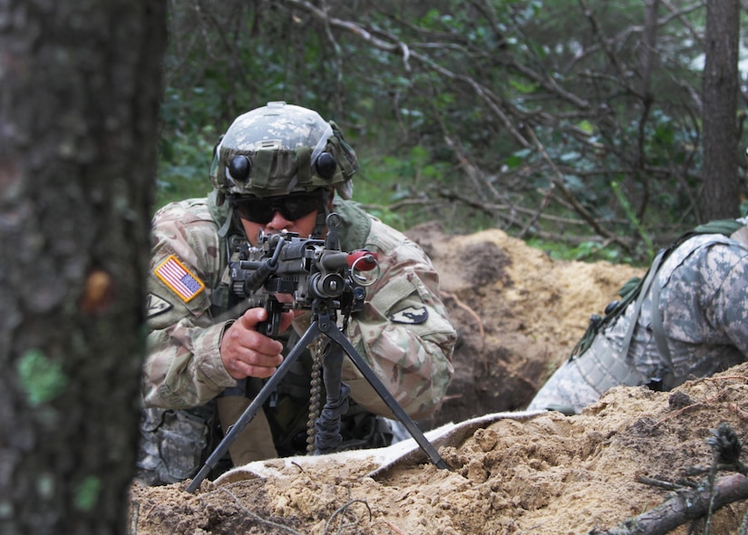FORT MCCOY, Wis. – U.S. Army Reserve Soldier, Spc. Juan Adorno, from Morovis, Puerto Rico, a military policeman with the 301st MP Company, Puerto Rico, surveys the base perimeter from a foxhole during a combat support training exercise at Fort McCoy, Wis., Aug. 19, 2016. The 301st was tasked with provided base defense during the exercise, which included foxhole perimeter defense, theater defense facility security, quick reaction force teams and entry control point teams. (U.S. Army Reserve Photo by Sgt. Quentin Johnson, 211th Mobile Public Affairs Detachment/Released)