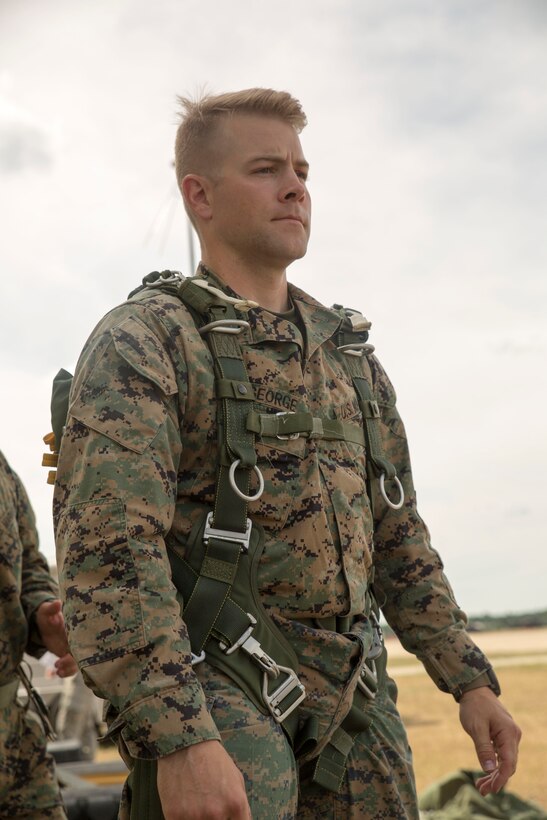 CAMP GRAYLING, Mich. – Capt. Patrick George, company commander of Company C, 4th Reconnaissance Battalion, Marine Forces Reserve, gets his parachute strapped and checked before a jump during Exercise Northern Strike 2016 at Camp Grayling Joint Maneuver Training Center, Mich., Aug. 16, 2016. The Reserve Marines practice jumping from the back of C-130s to meet their requirements and perfect their skills.  The Marines looked each other over ensure all the jumps were safe and efficient by checking all the straps and cords were working efficiently for a safe launch of the parachute. (U.S. Marine Corps photo by Cpl. Devan Alonzo Barnett/Released)