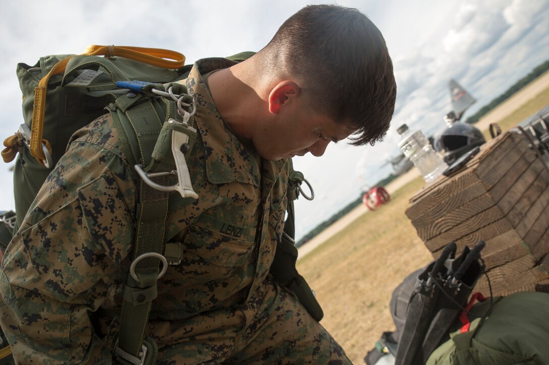 CAMP GRAYLING, Mich. – Maj. Mark Lenzi, Inspector-Instructor Company C, Headquarters and Support Company, 4th Reconnaissance Battalion, Marine Forces Reserve, gets his parachute strapped and checked before a jump during Exercise Northern Strike 2016 at Camp Grayling Joint Maneuver Training Center, Mich., Aug. 16, 2016. The Reserve Marines practice jumping from the back of C-130s to meet their requirements and perfect their skills.  The Marines looked each other over ensure all the jumps were safe and efficient by checking all the straps and cords were working efficiently for a safe launch of the parachute. (U.S. Marine Corps photo by Cpl. Devan Alonzo Barnett/Released)