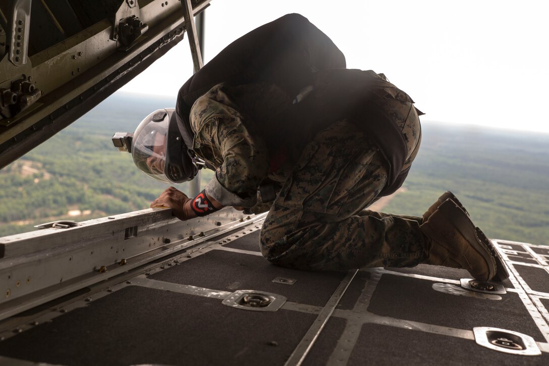 CAMP GRAYLING, Mich. -- Sgt. Juan Gonzalez, paraloft chief for Company C, 4th Reconnaissance Battalion, Marine Forces Reserve, checks the distance left before a jump during Exercise Northern Strike 2016 at Camp Grayling Joint Maneuver Training Center, Mich., Aug. 16, 2016. Reserve Recon Marines practice jumping from the back of C-130s to meet their requirements and perfect their skills.  Exercise Northern Strike 16 is a National Guard Bureau-sponsored exercise uniting approximately 5,000 Army, Air Force, Marine, and Special Forces service members from 20 states and three coalition countries. The exercise strives to provide accessible, readiness-building opportunities for military units from all service branches to achieve and sustain proficiency in conducting mission command, air, sea, and ground maneuver integration, and the synchronization of fires in a joint, multinational, decisive action environment. (U.S. Marine Corps photo by Cpl. Devan Alonzo Barnett/Released)
