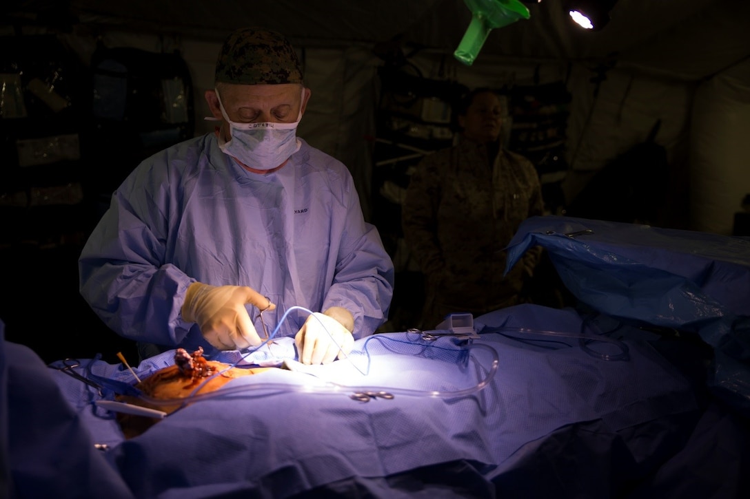 Navy Capt. Joseph P. Costabile, vascular/general surgeon with 4th Medical Battalion, 4th Marine Logistics Group, Marine Forces Reserve, performs surgery on a simulated casualty during Exercise Global Medic at Fort McCoy, Wisconsin, Aug. 16, 2016. Throughout the course of the exercise, casualties with various injuries were sent to the Shock Trauma Platoon and then to the operating room where the medical staff would quickly evaluate them and perform the necessary treatment for stabilization, such as the casualty depicted above who had shrapnel stuck in his chest from an improvised explosive device. (U.S. Marine Corps photo by Lance Cpl. Melissa Martens/Released)