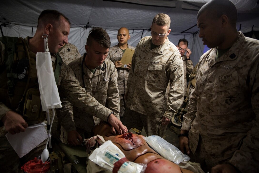 Naval Medical staff from 4th Medical Battalion, 4th Marine Logistics Group, Marine Forces Reserve, asses the injuries on a simulated casualty brought to the Shock Trauma Platoon during Exercise Global Medic at Fort McCoy, Wisconsin, Aug. 20, 2016. Throughout the course of the exercise, casualties would be brought to the STP with various injuries and the medical staff would need to react quickly to stabilize the patient and provide the proper medical treatment. (U.S. Marine Corps photo by Lance Cpl. Melissa Martens/Released)