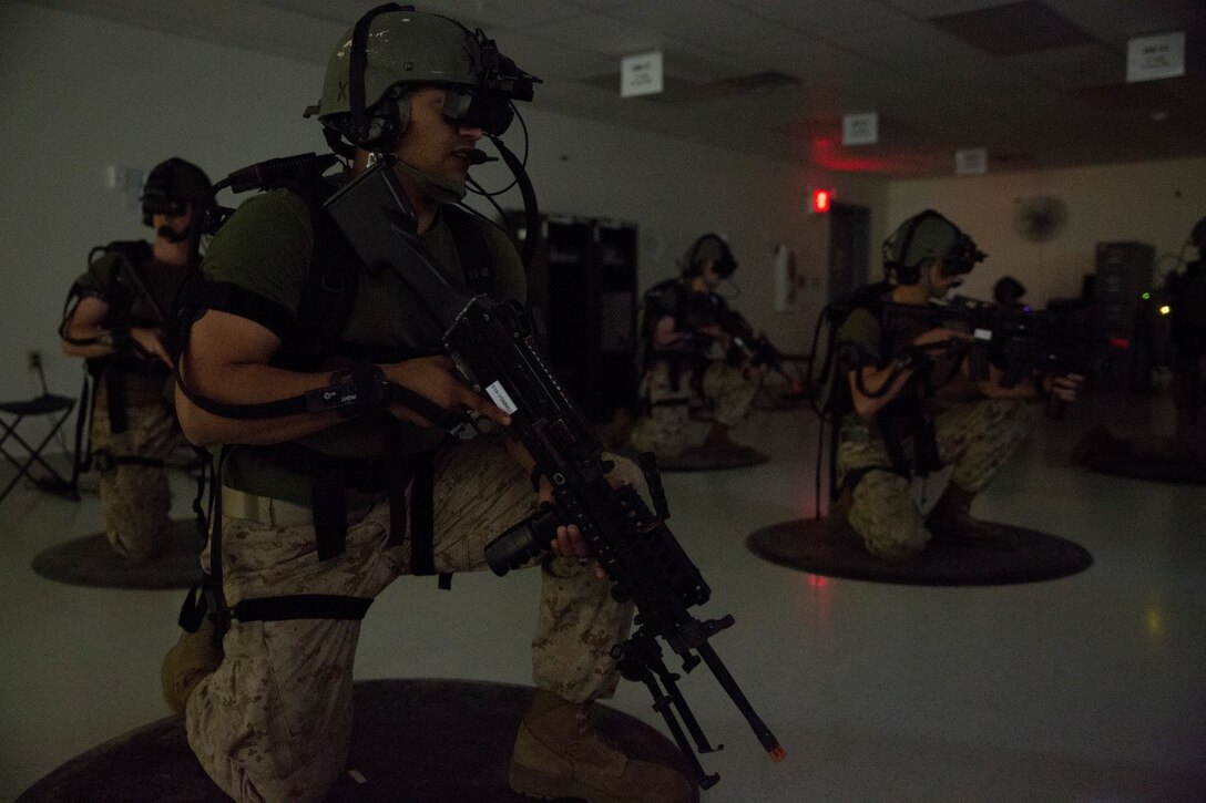 Motor Transport Marines with 4th Medical Battalion, 4th Marine Logistics Group, Marine Forces Reserve, train on a virtual patrol mission during Exercise Global Medic at Fort McCoy, Wisconsin, Aug. 18, 2016. Using the equipment, Marines were able to see and hear the virtual environment with members of their squad, make contact with enemy forces, clear rooms and patrol through the rally point at the end of the course. (U.S. Marine Corps photo by Lance Cpl. Melissa Martens/Released)