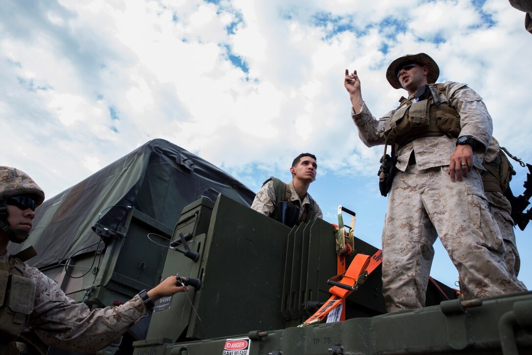Sgt. Charles P. Retter (right), motor transport maintenance chief with 4th Medical Battalion, 4th Marine Logistics Group, Marine Forces Reserve, teaches Marines how to properly utilize new trailers for the 7-ton truck during Exercise Global Medic at Fort McCoy, Wisconsin, Aug. 18, 2016. By explaining how new equipment is used, Retter is ensuring that his Marines will be ready in a combat zone to use their skills to fulfill the mission requirements. (U.S. Marine Corps photo by Lance Cpl. Melissa Martens/Released)  