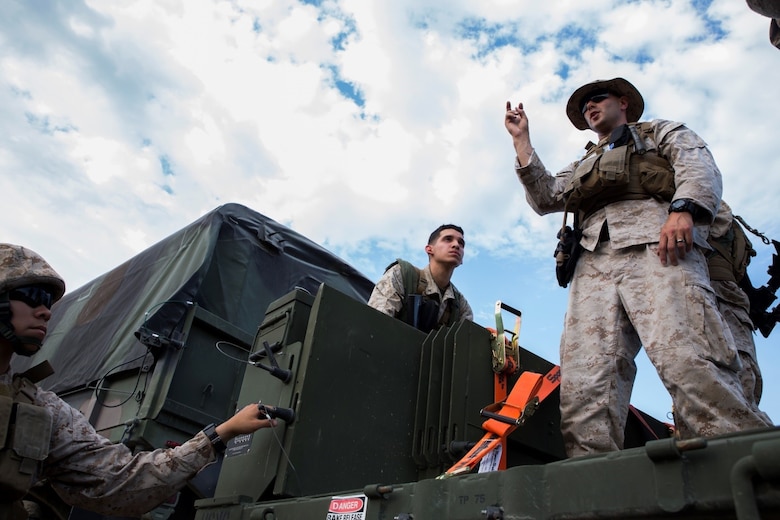 Sgt. Charles P. Retter (right), motor transport maintenance chief with 4th Medical Battalion, 4th Marine Logistics Group, Marine Forces Reserve, teaches Marines how to properly utilize new trailers for the 7-ton truck during Exercise Global Medic at Fort McCoy, Wisconsin, Aug. 18, 2016. By explaining how new equipment is used, Retter is ensuring that his Marines will be ready in a combat zone to use their skills to fulfill the mission requirements. (U.S. Marine Corps photo by Lance Cpl. Melissa Martens/Released)  