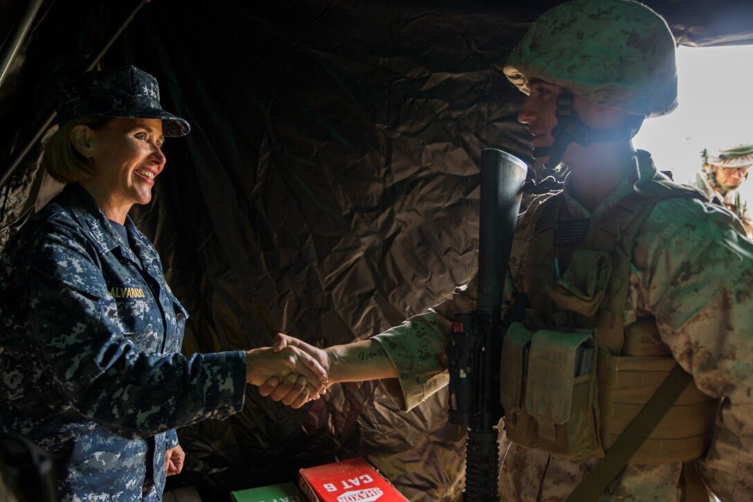 Lance Cpl. Vicente C. Spence (right), a motor transport operator with 4th Medical Battalion, 4th Marine Logistics Group, Marine Forces Reserve, receives a challenge coin from Rear Adm. Christina M. Alavarado, commander, reserve component expeditionary medicine, during Exercise Global Medic at Fort McCoy, Wisconsin, Aug. 19, 2016. Spence was presented the coin for the continuous hard work he did throughout the course of the exercise and for constantly maintaining a positive and upbeat attitude. (U.S. Marine Corps photo by Lance Cpl. Melissa Martens/Released) 