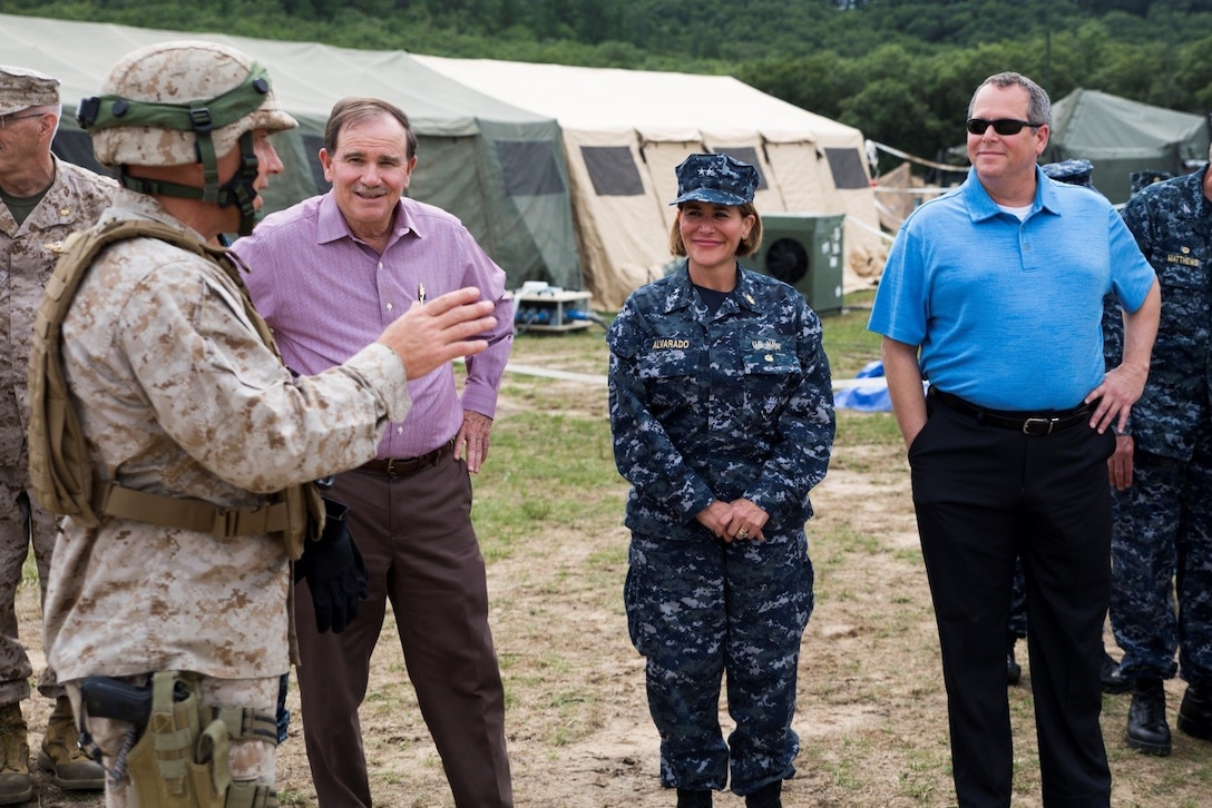 Navy Capt. Michael L. Reineke (left), commanding officer of Exercise Global Medic, provides distinguished visitors with an overview of the training the Marines and Navy personnel have been participating in throughout the course of the exercise at Fort McCoy, Wisconsin, Aug. 19, 2016. The distinguished visitors included Dennis Biddick (second from the left), deputy assistant secretary of the Navy Reserve Affairs, Rear Adm. Christina M. Alavarado (second from right), commander, reserve component expeditionary medicine, and Dr. Andrew Jones (right), director of the Navy Total Force Bureau of Medicine and Surgery. (U.S. Marine Corps photo by Lance Cpl. Melissa Martens/Released)