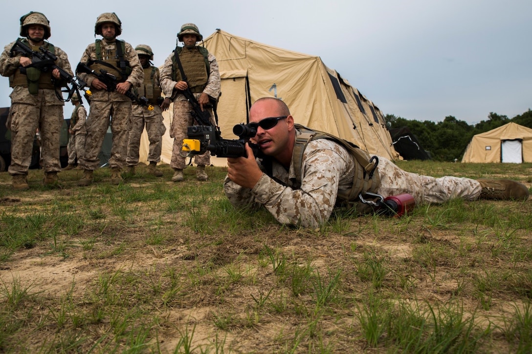 Cpl. Kristophore K. Allison, motor transport operator with 4th Medical Battalion, 4th Marine Logistics Group, Marine Forces Reserve, teaches a class on proper weapons handling and techniques to Navy personnel during Exercise Global Medic at Fort McCoy, Wisconsin, Aug. 19, 2016. Participants had the opportunity to cross train with other branches and other military occupational specialties to develop different skills throughout the course of the exercise. (U.S. Marine Corps photo by Lance Cpl. Melissa Martens/Released)