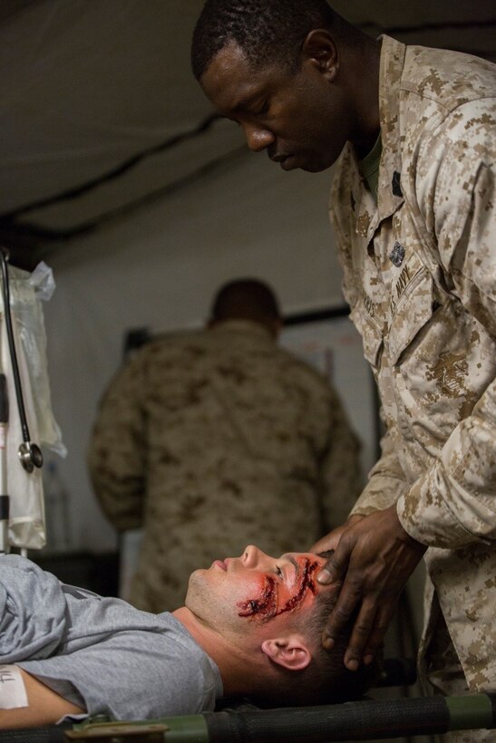 Petty Officer 2nd Class Mark A. Harris, a hospital corpsman with 4th Medical Battalion, 4th Marine Logistics Group, Marine Forces Reserve, provides care to a simulated casualty in the Shock Trauma Platoon during Exercise Global Medic at Fort McCoy, Wisconsin, Aug. 19, 2016. The live scenario training will ensure that corpsman are well prepared in a combat zone and will have all the necessary capabilities to accomplish the mission. (U.S. Marine Corps photo by Lance Cpl. Melissa Martens/Released) 
