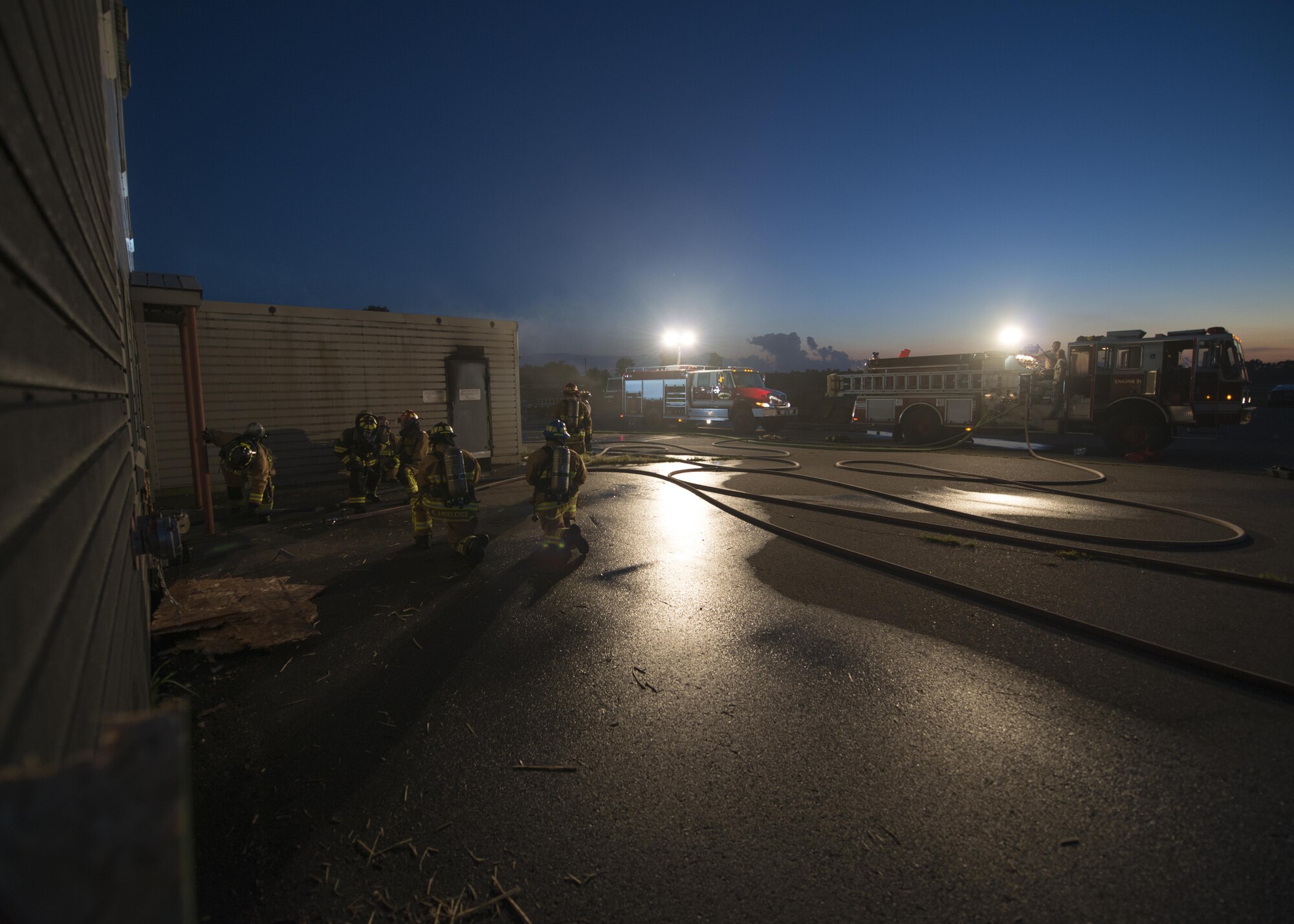 Firefighters throughout the Air Force Reserve prepare to enter building during exercise Patriot Warrior Aug. 17, 2016, Sparta/Fort McCoy Airport, Wis. Patriot Warrior allows Air Reserve fire fighting units from throughout the U.S. to train together and learn from professionals throughout the career field in a deployment-style environment. (U.S. Air Force Photo/ Tech. Sgt. Nathan Rivard)