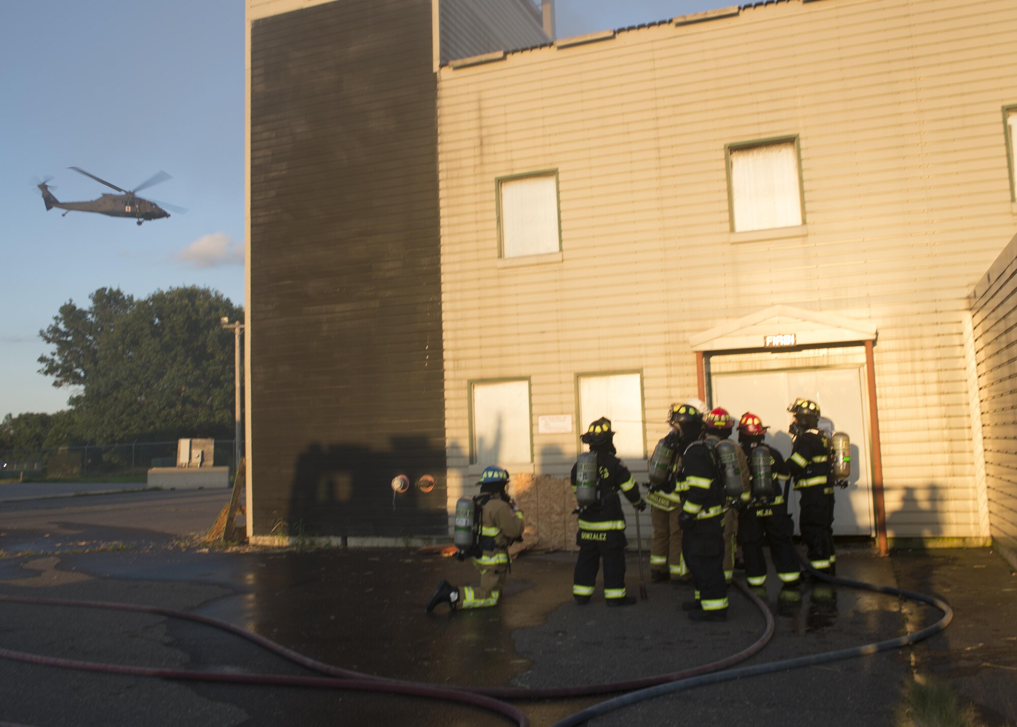 Firefighters throughout the Air Force Reserve prepare to enter building during exercise Patriot Warrior Aug. 17, 2016, Sparta/Fort McCoy Airport, Wis. Patriot Warrior allows Air Reserve fire fighting units from throughout the U.S. to train together and learn from professionals throughout the career field in a deployment-style environment. (U.S. Air Force Photo/ Tech. Sgt. Nathan Rivard)