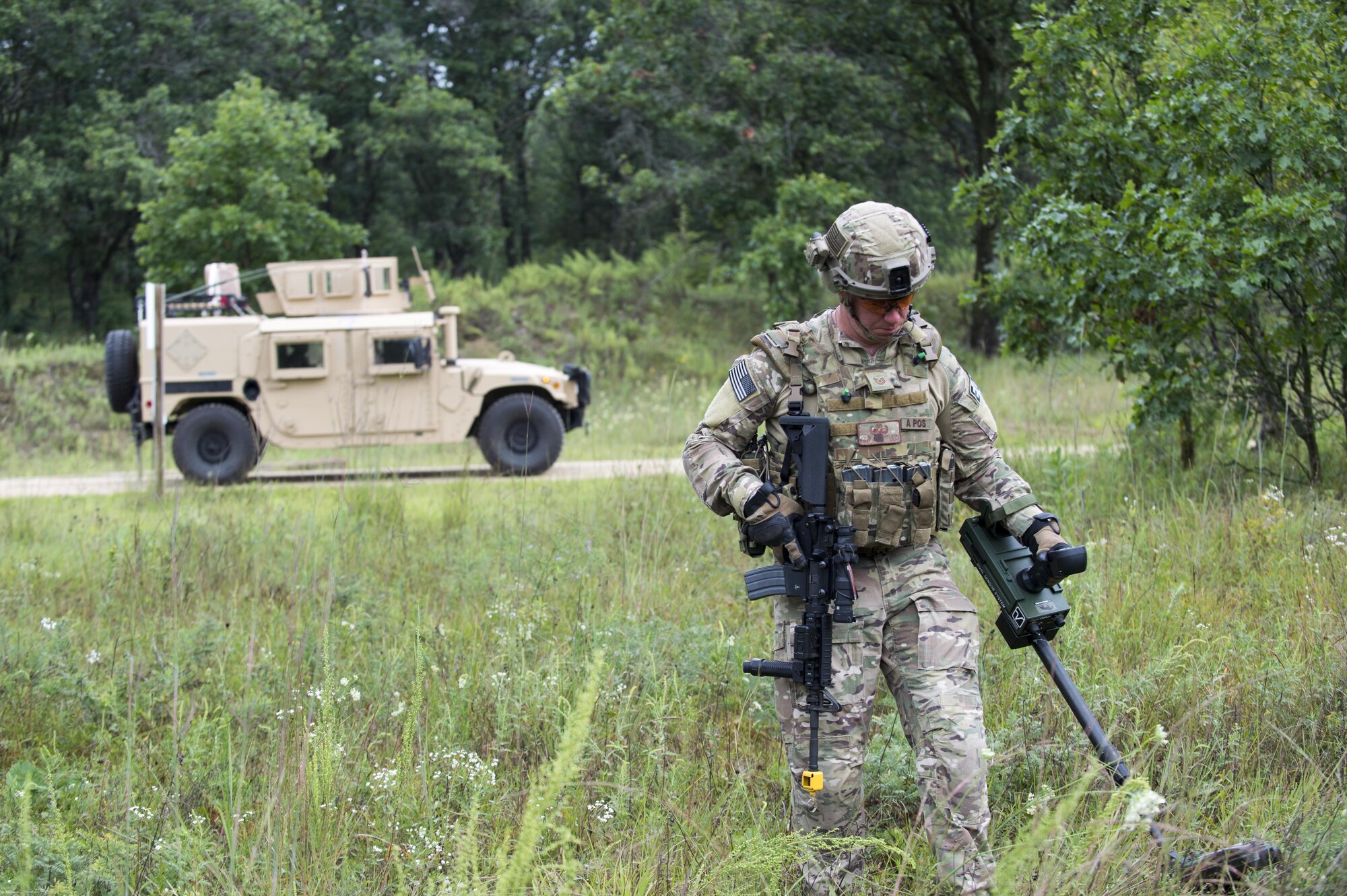 Tech Sgt. John Nelson, 512th Civil Engineer Squadron explosive ordinance disposal technician, clears a path to create a detonation site using a Minehound dual-sensor-metal detector during exercise Patriot Warrior Aug. 17, 2016, Fort. McCoy, Wis. Air Force EOD technicians work together during Patriot Warrior to expand their skills and learn from other professionals in their career field during the deployment training exercise. (U.S. Air Force Photo/ Tech. Sgt. Nathan Rivard)