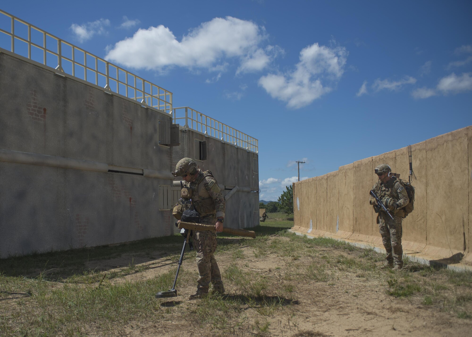 Staff Sgt. Kyle Preece, 442th Civil Engineer Squadron explosive ordinance disposal technician, uses a Minehound dual-sensor-metal detector to clear his team’s path while Senior Airman Justin Devantier, 914th Civil Engineer Squadron explosive ordinance disposal technician, provides security during exercise Patriot Warrior Aug. 17, 2016, Fort McCoy, Wis. Patriot Warrior allows EOD technicians throughout the Air Force to train their professional skills in a deployment-style environment. (U.S. Air Force Photo/ Tech. Sgt. Nathan Rivard)