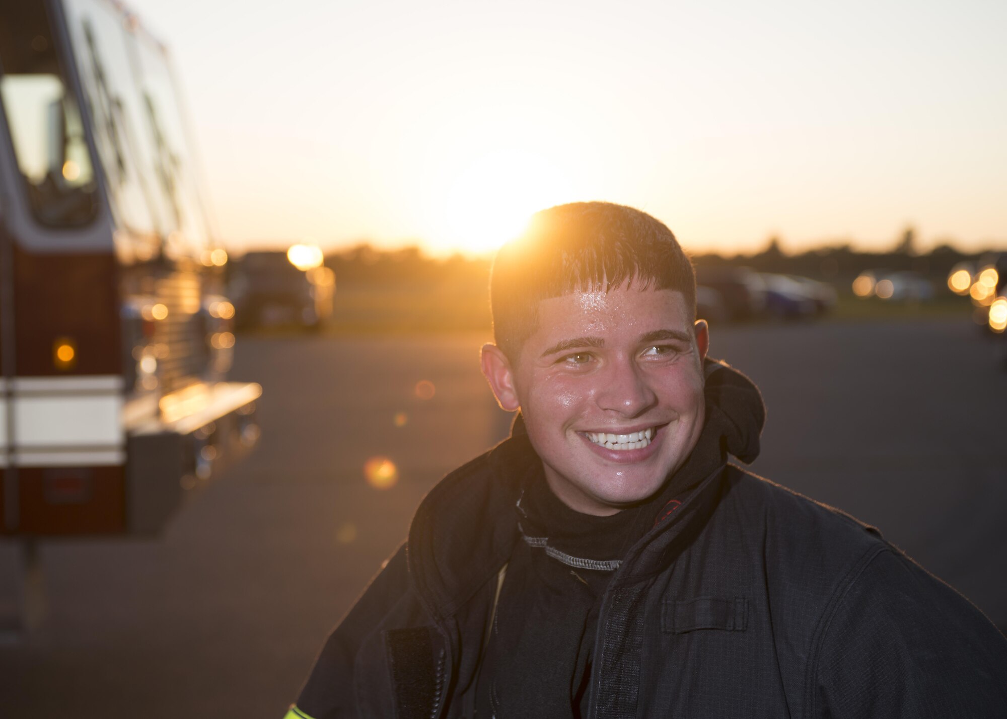 Senior Airman Ian Gonzalez, 512th Civil Engineer Squadron firefighter, smiles after successfully completing a round on the rescue team during building live-burn training at exercise Patriot Warrior Aug. 17, 2016, Sparta/Fort McCoy, Wis. Patriot Warrior allows Air Reserve fire fighting units from throughout the U.S. to train together and learn from professionals throughout the career field in a deployment-style environment. (U.S. Air Force Photo/ Tech. Sgt. Nathan Rivard)