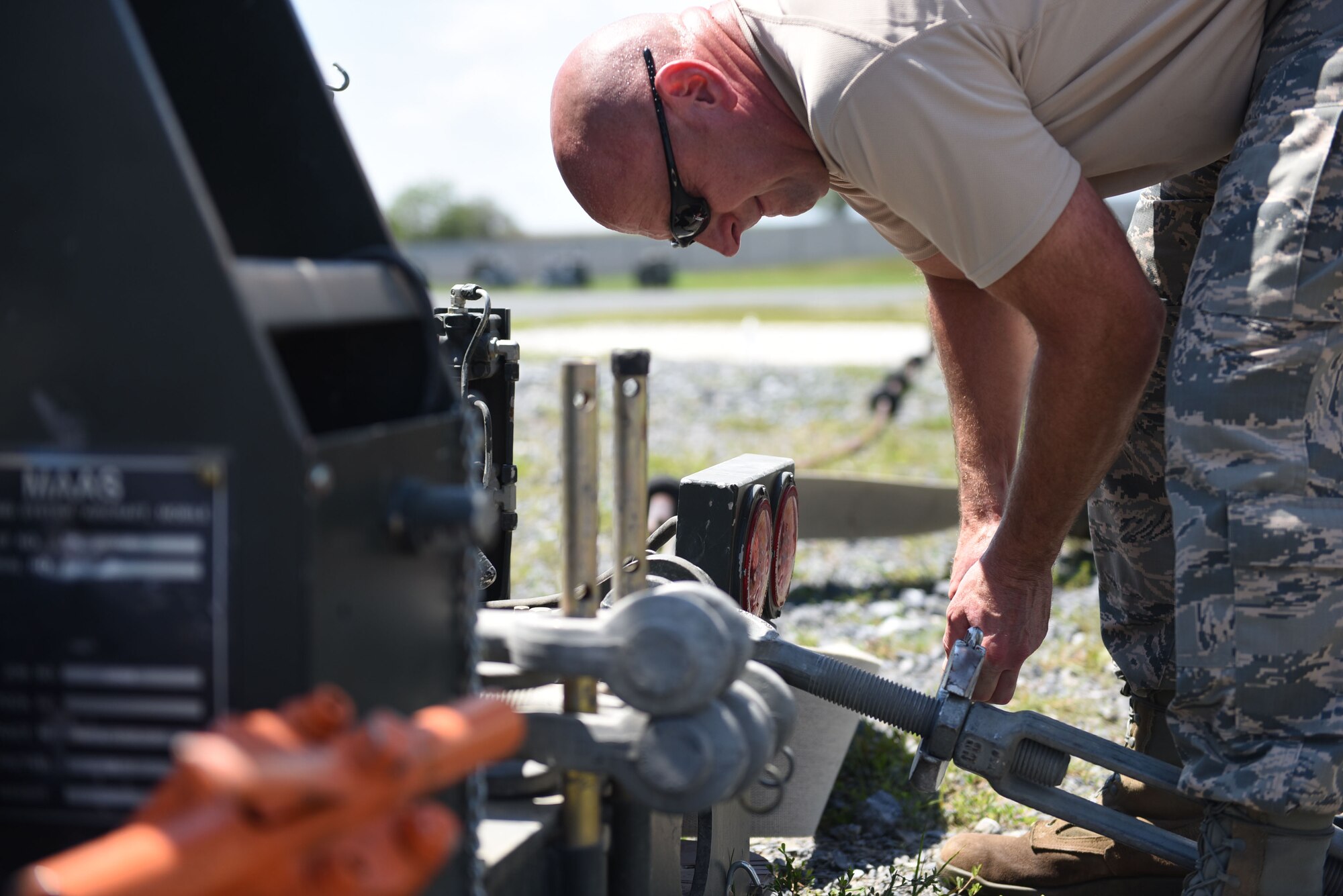 Master Sgt. Mark Hetzer, power production supervisor with the 911th Civil Engineer Squadron, works on a mobile aircraft arresting system during a training exercise at Fort Indiantown Gap, Pennsylvania, August 13, 2016. The goal of the training was to give Airmen an opportunity to work hands-on with equipment like MAAS units.(U.S. Air Force photo by Airman 1st Class Bethany Kobily)