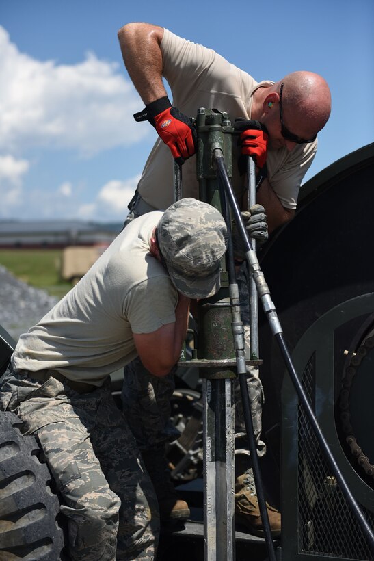 Master Sgt. Mark Hetzer, power production supervisor with the 911th Civil Engineer Squadron, and Staff Sgt. Nathan Patton, power production specialist with the 911th CES, work on a mobile aircraft arresting system during a training exercise at Fort Indiantown Gap, Pennsylvania, August 13, 2016. The two-day training exercise gave Airmen an opportunity to get hands-on training, rather than computer-based training, over their unit training assembly weekend. (U.S. Air Force photo by Airman 1st Class Beth Kobily