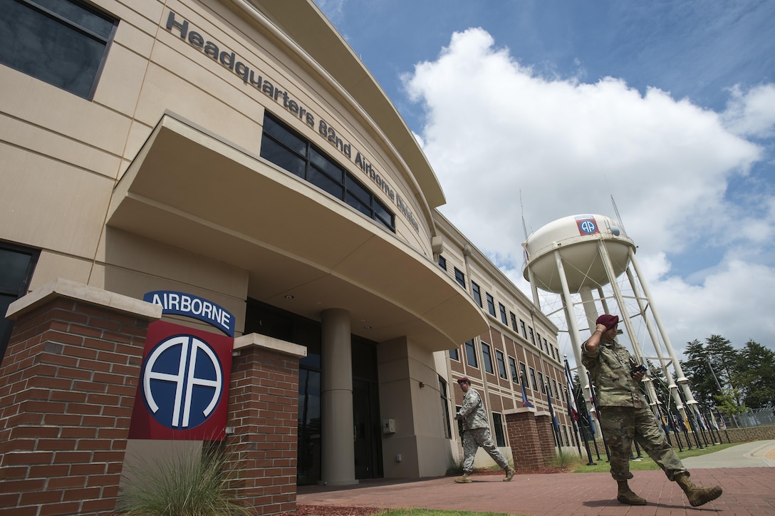 Soldiers from the 82nd Airborne Division enter and exit the headquarters building on Fort Bragg, N.C., Aug. 4, 2016. Ongoing work by the Air Force and Army has filled training schedules by streamlining the Joint Airborne/Air Transportability Training program, an online system used by military units to request air support. (U.S. Air Force photo/Master Sgt. Brian Ferguson)