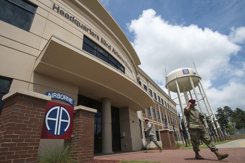 Soldiers from the 82nd Airborne Division enter and exit the headquarters building on Fort Bragg, N.C., Aug. 4, 2016. Ongoing work by the Air Force and Army has filled training schedules by streamlining the Joint Airborne/Air Transportability Training program, an online system used by military units to request air support. (U.S. Air Force photo/Master Sgt. Brian Ferguson)