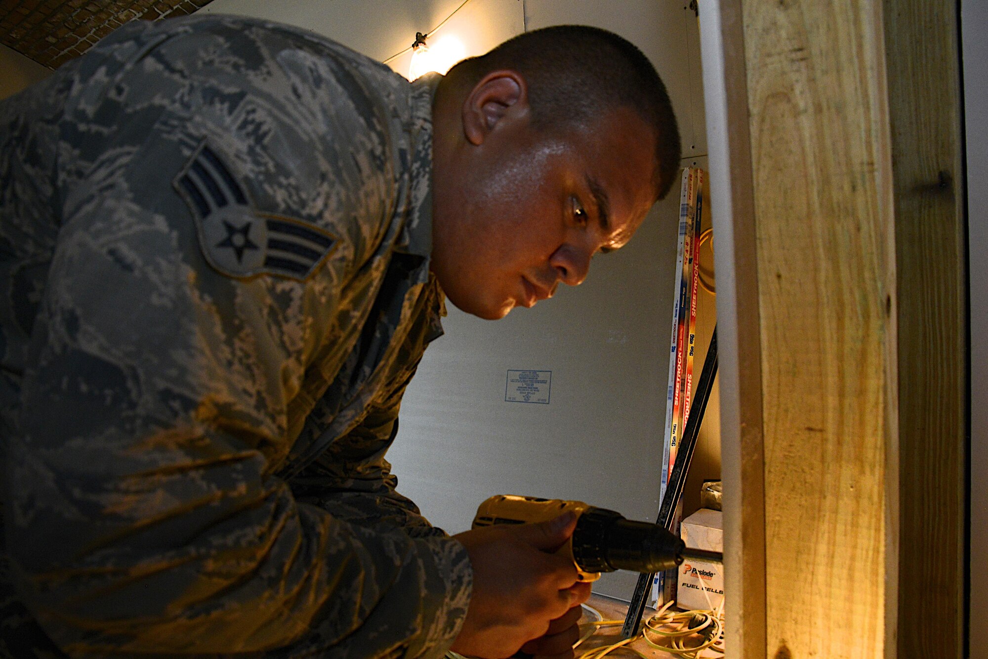 Senior Airman Michael Chinchilla, a 482nd Civil Engineering Squadron engineering assistant, drills screws into drywall during renovation efforts at Fort Jefferson, in the Dry Tortugas, Florida, Aug. 15. Airmen from the 482nd CES are renovating crew quarters for scientific research teams who visit the historical site studying wildlife in the area. The Innovative Readiness Training program allows Department of Defense and civilian entities partner together for projects like this. (U.S. Air Force photo by Senior Airman Frank Casciotta)