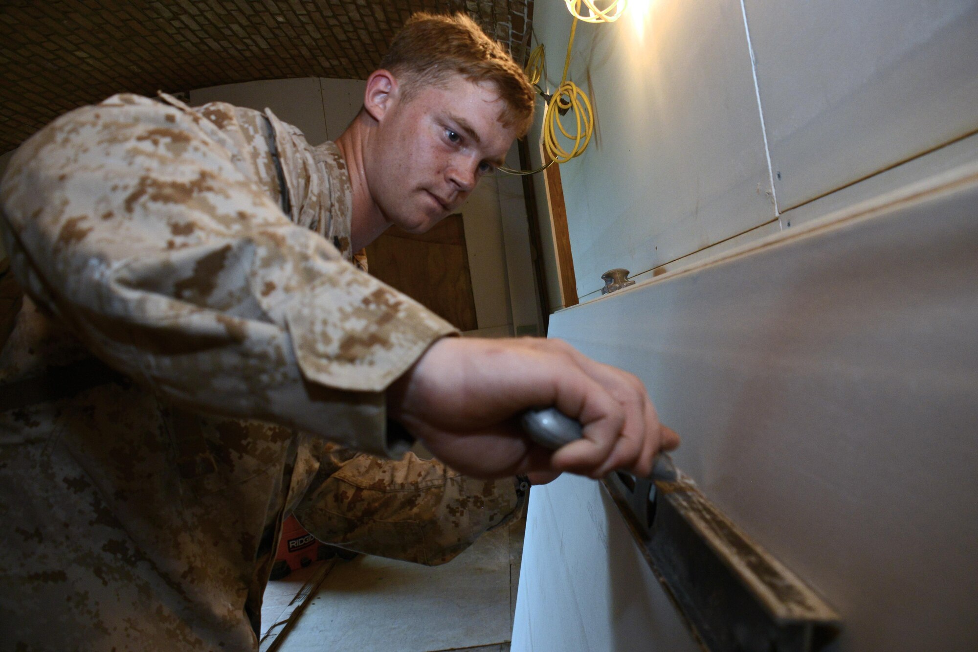 Marine Cpl. Thomas A. Trinosky, a 25th Combat Logistics Battalion combat engineer, cuts a sheet of drywall during renovation efforts at Fort Jefferson, in the Dry Tortugas, Florida, Aug. 15. Airmen from the 482nd CES are renovating crew quarters for scientific research teams who visit the historical site studying wildlife in the area. The Innovative Readiness Training program allows Department of Defense and civilian entities partner together for projects like this. (U.S. Air Force photo by Senior Airman Frank Casciotta)