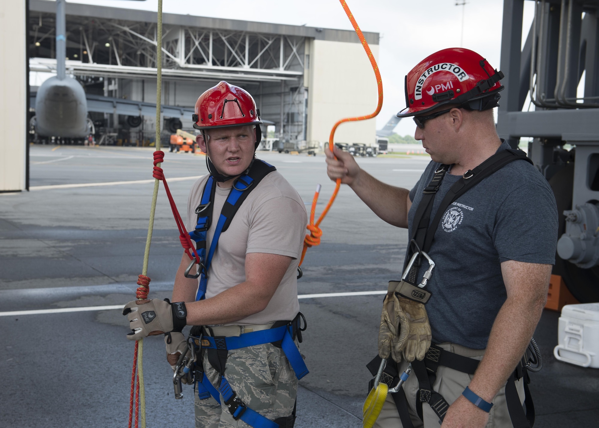 Staff Sgt. Matthew Keenan, Louis F. Garland Department of Defense Fire Academy rescue technician instructor, inspects the harness and rigging of Senior Airman Adam Green, 87th Civil Engineer Squadron firefighter, harness and rigging during a Rescue Technician Course Aug. 18, 2016, at Dover Air Force Base, Del. Green was one of two students from Joint Base McGuire-Dix-Lakehurst, N J, to attend the course at Dover AFB. (U.S. Air Force photo by Senior Airman Zachary Cacicia) 