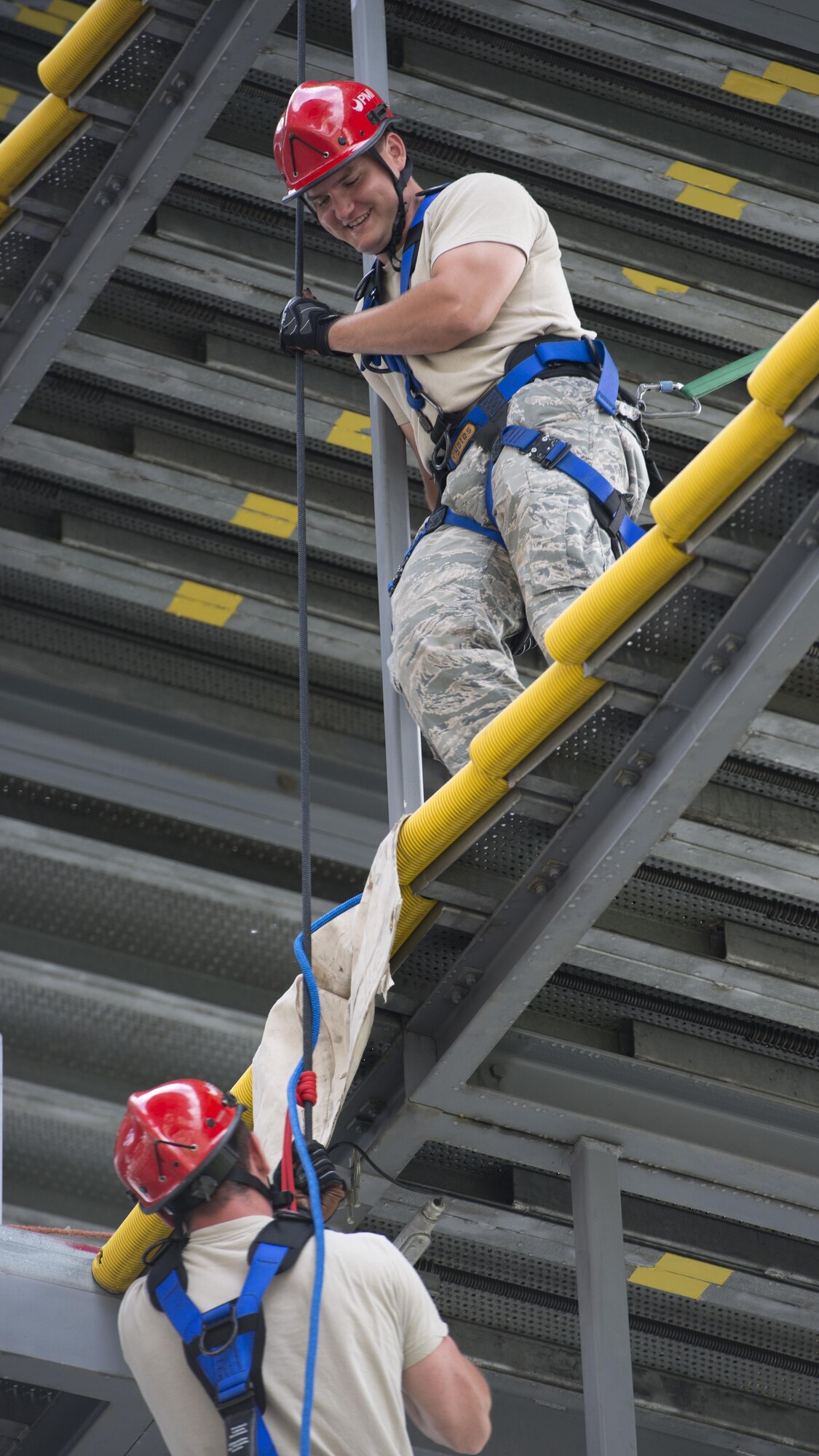Senior Airman Dallas Gullion, 436th Civil Engineer Squadron firefighter, guides a rope while another firefighter practices ascending and repelling during a Rescue Technician Course Aug. 18, 2016, at Dover Air Force Base, Del. Upon completion of this course, students are National Fire Protection Association certified rope rescue and confined space rescue technicians. (U.S. Air Force photo by Senior Airman Zachary  Cacicia)