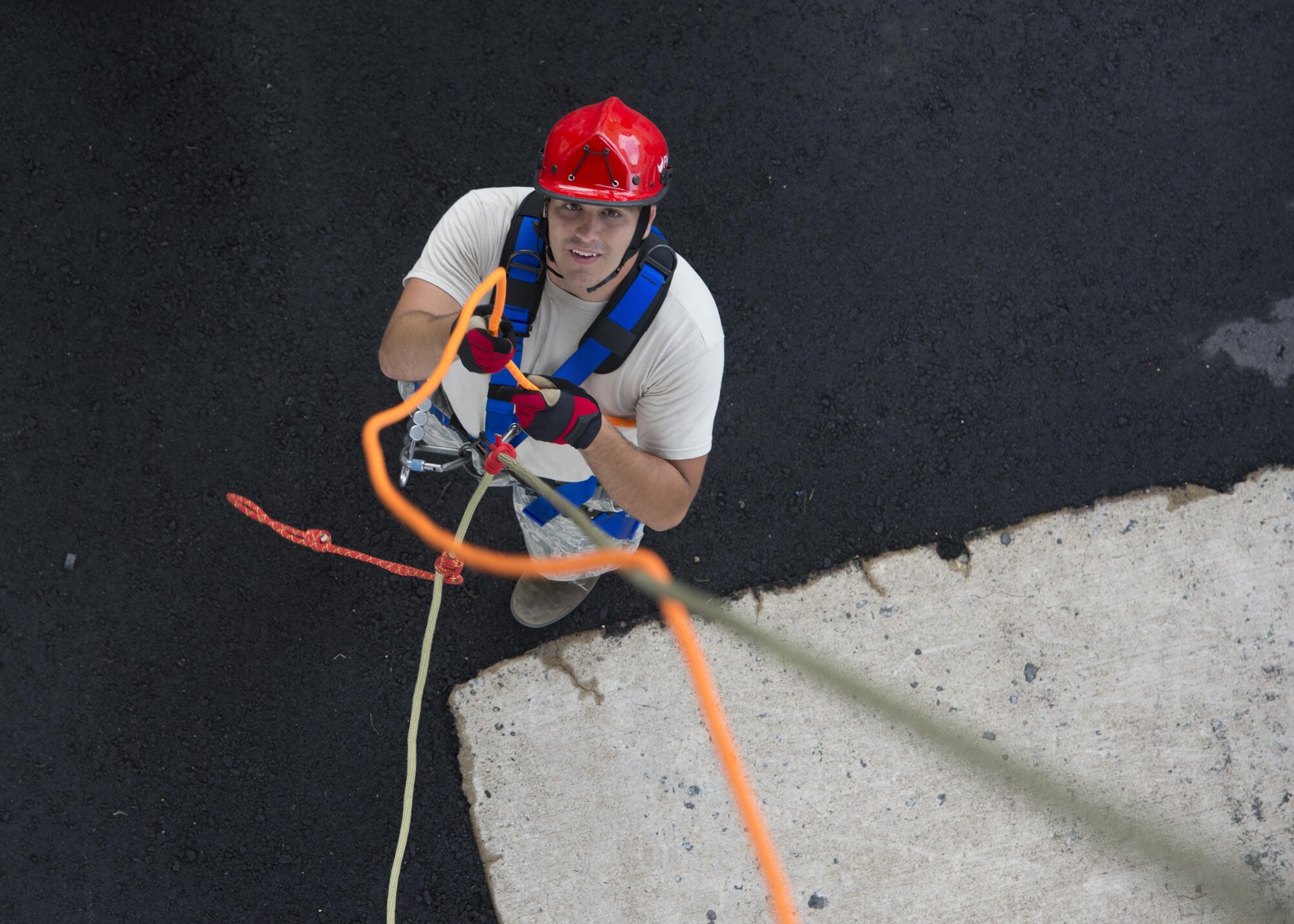 Senior Airman James Marker, 436th Civil Engineer Squadron firefighter, untangles climbing ropes prior to making an ascent during a Rescue Technician Course Aug. 18, 2016, at Dover Air Force Base, Del. This course increased the number of certified rescue personnel in the 436th CES Fire Department by 35 percent. (U.S. Air Force photo by Senior Airman Zachary Cacicia)