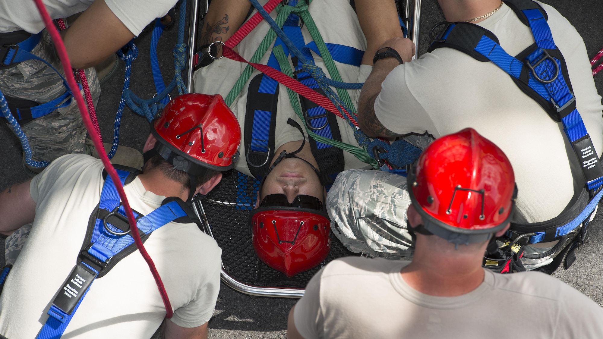 Senior Airman Shawn Davis, 436th Civil Engineer Squadron firefighter, is strapped into a basket stretcher by his classmates during a Rescue Technician Course Aug. 18, 2016, at Dover Air Force Base, Del. This training taught students proper and safe methods of rescuing injured victims from hard-to-reach places. (U.S. Air Force photo by Senior Airman Zachary Cacicia)