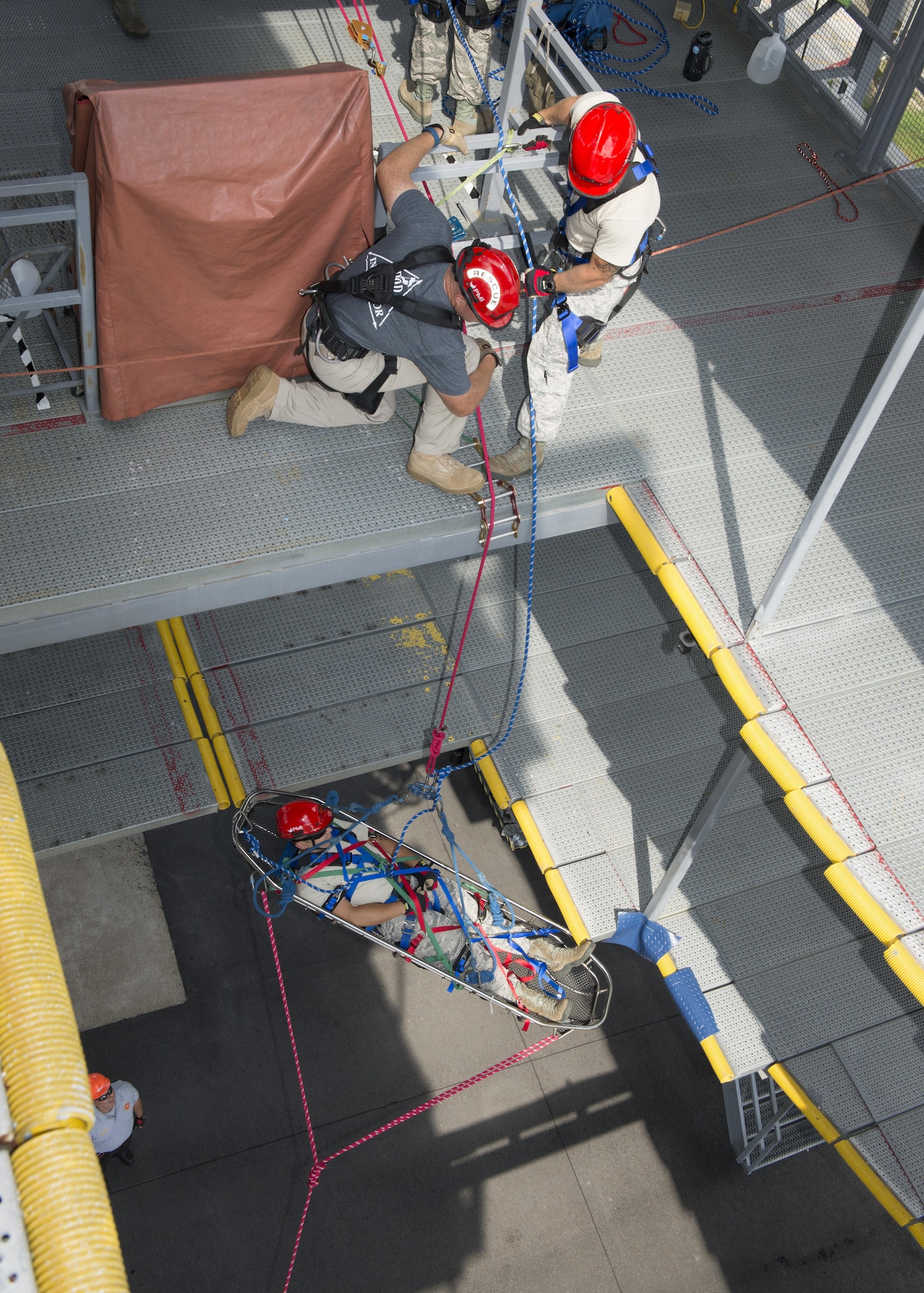 Senior Airman Shawn Davis, 436th Civil Engineer Squadron firefighter, is pulled up a structure with ropes during a Rescue Technician Course Aug. 18, 2016, at Dover Air Force Base, Del. For this training scenario, Davis acted as a simulated injured victim. (U.S. Air Force photo by Senior Airman Zachary Cacicia)