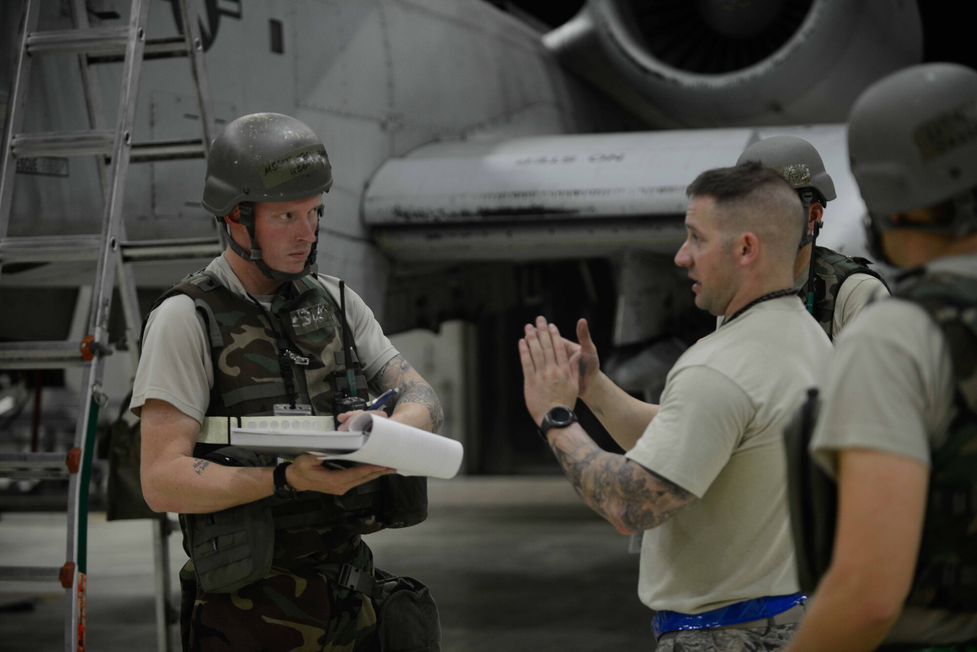 Airmen from the 51st Maintenance Group discuss preflight inspections during Exercise Beverly Herd 16-2 at Osan Air Base, Republic of Korea. The 51st MXG maintain and inspect the A-10 Thunderbolt II aircraft, which provides close air support, air strike control and combat search and rescue capabilities to the 51st Fighter Wing in support of the defense of the ROK. (U.S. Air Force photo by Senior Airman Dillian Bamman)