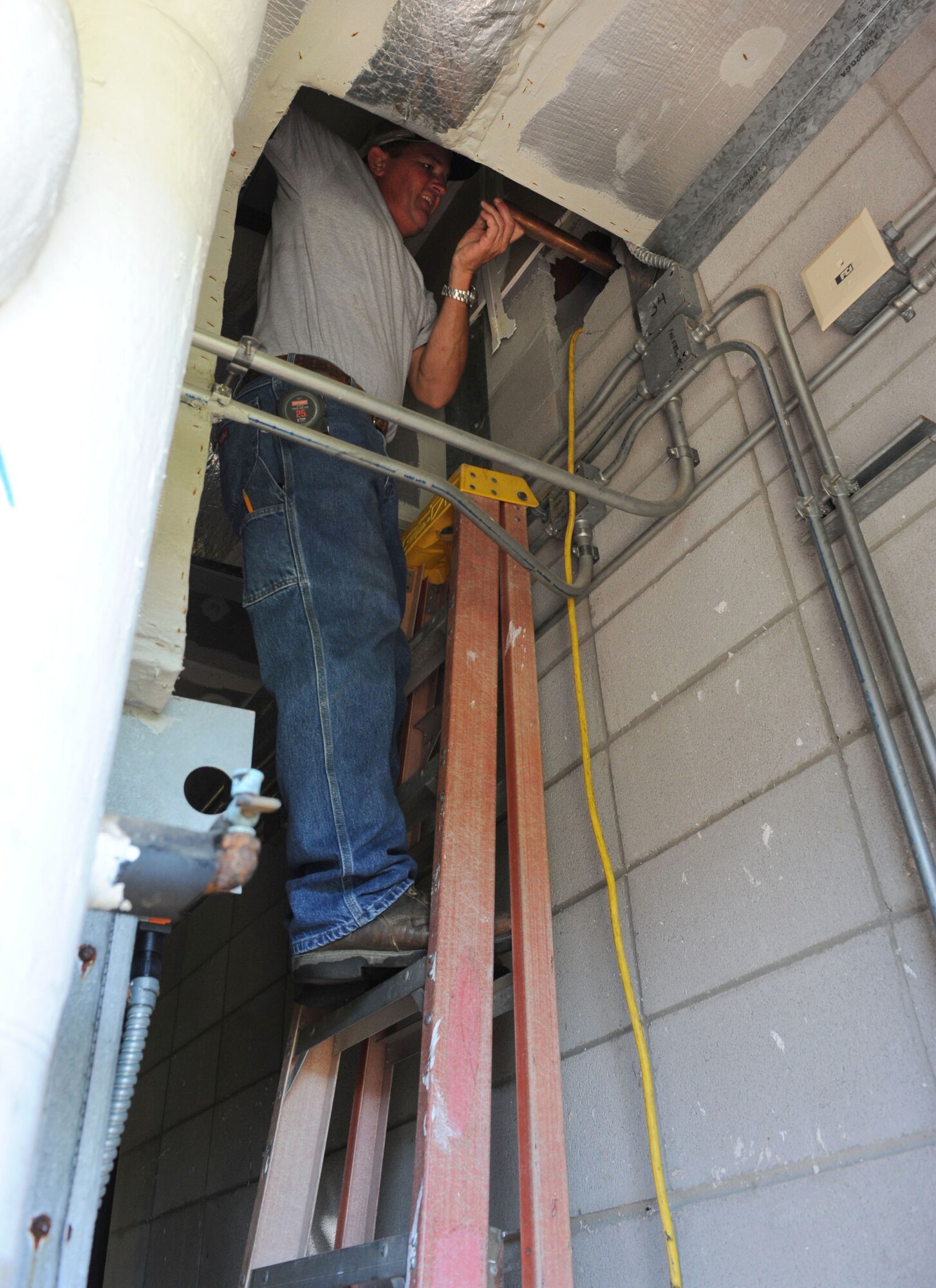 Carl Peebles, DNP Inc. plumber, installs new kitchen water lines at the McBride Commons Aug. 22, 2016, on Keesler Air Force Base, Miss. The renovation will include a children’s library, computer stations, engraving, framing, marketing and print shops and a full kitchen. The nine-month-long project is expected to be completed by May 2017. (U.S. Air Force photo by Kemberly Groue/Released)