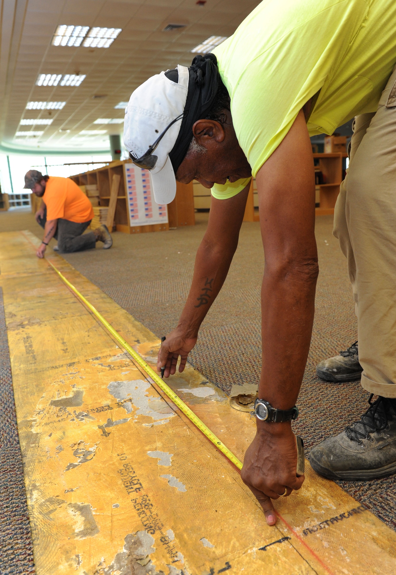 Layton Gipson and Ervin Morgan, Specialty Contractors and Associates, Inc. laborers, take measurements before  installing framing at the McBride Commons Aug. 22, 2016, on Keesler Air Force Base, Miss. The renovation will include a children’s library, computer stations, engraving, framing, marketing and print shops and a full kitchen. The nine-month-long project is expected to be completed by May 2017. (U.S. Air Force photo by Kemberly Groue/Released)