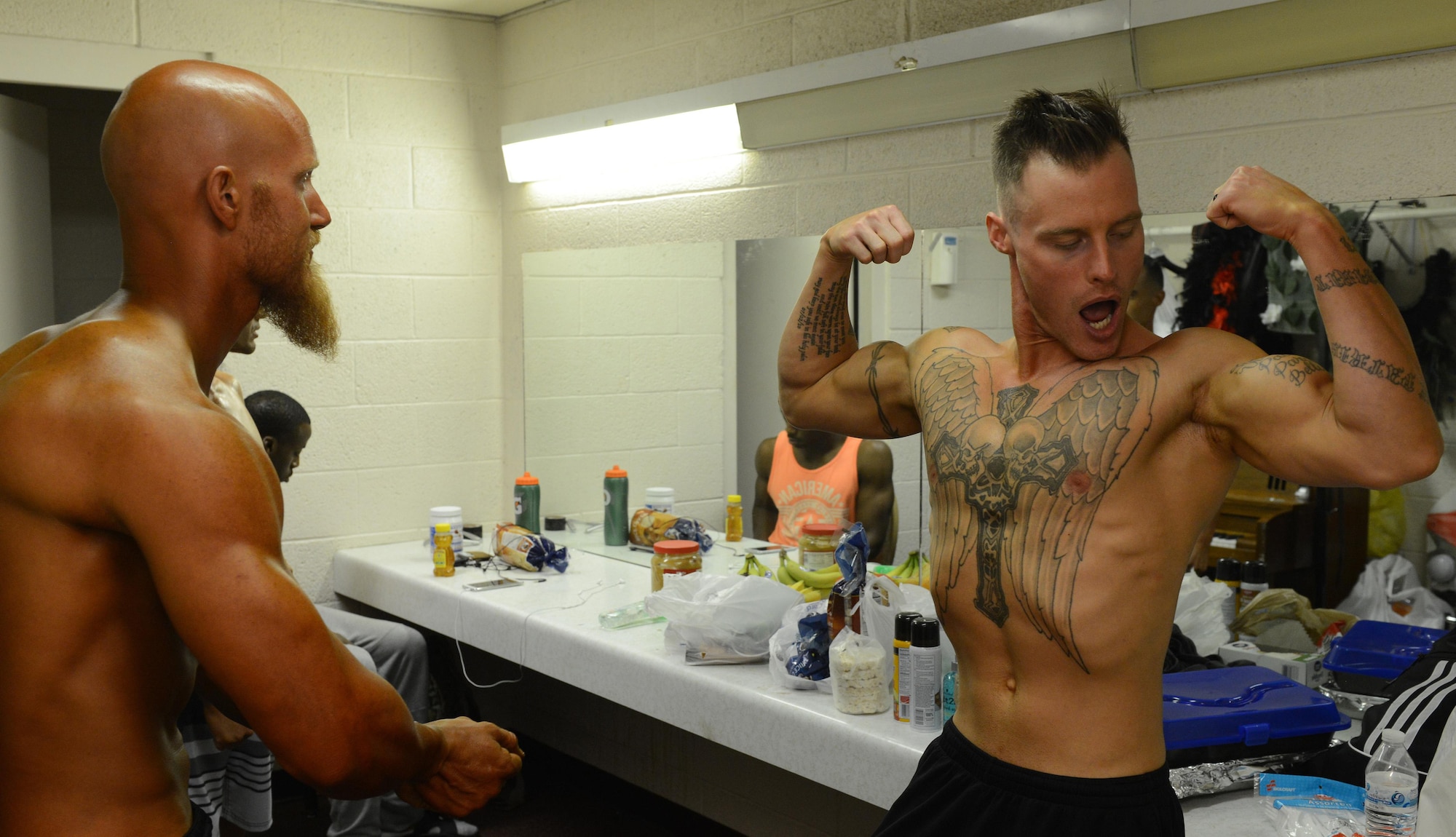 From left, Shawn Barkhaus and Kyle Reinhart practice poses prior to the Bodybuilding, Bikini and Figure competition at Luke Air Force Base, Ariz., Aug. 20, 2016. Both ran unopposed in their weight class but competed for overall bodybuilder. (U.S. Air Force photo by Senior Airman James Hensley)