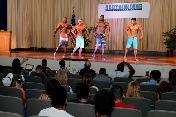 The men competing in the physique tall category line up for the judges during the main event of the Bodybuilding, Bikini and Figure competition at Luke Air Force Base, Ariz., Aug. 20, 2016. (U.S. Air Force photo by Senior Airman James Hensley)