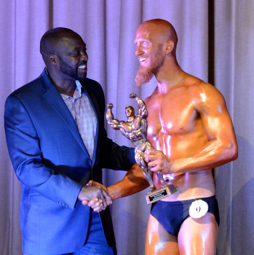 Ansel Bingham, Bryant Fitness Center director shakes hands with Shawn Barhaus, winner of the overall men’s bodybuilder competition at Luke Air Force Base, Ariz., Aug. 20, 2016. (U.S. Air Force photo by Senior Airman James Hensley)