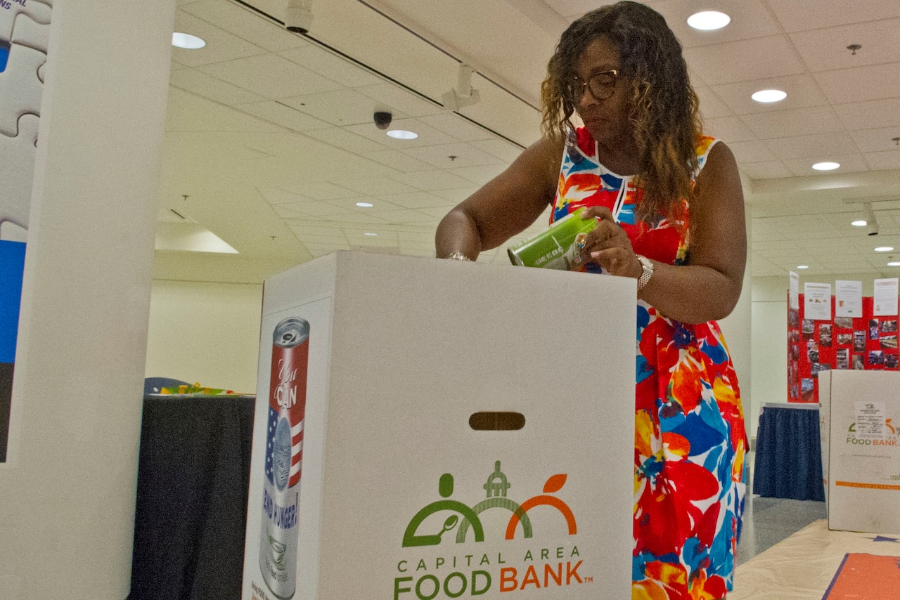 Defense Department employee Naniece Shields donates food for the Feds Feed Families food drive at the Pentagon, Aug. 23, 2016. "I know it's the right thing to do. A lot of people do go hungry," Shields said. "There are a lot of kids out here who do go hungry at night, so I just felt it was my duty." DoD photo by Lisa Ferdinando