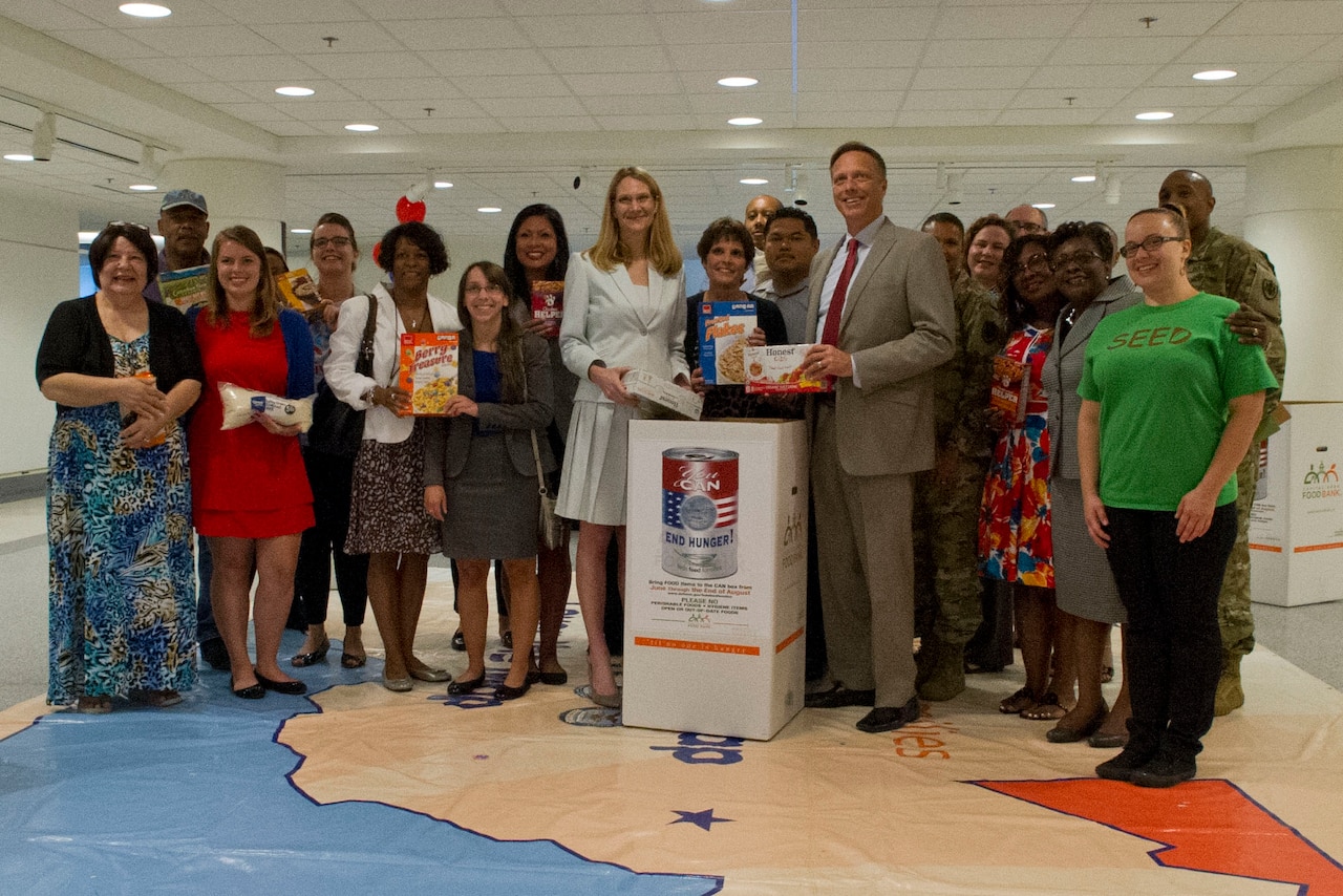Todd A. Weiler, assistant secretary of defense for manpower and reserve affairs, poses with federal workers and charity representatives at the Feds Feeding Families charity fair at the Pentagon, Aug. 23, 2016. DoD photo by Lisa Ferdinando