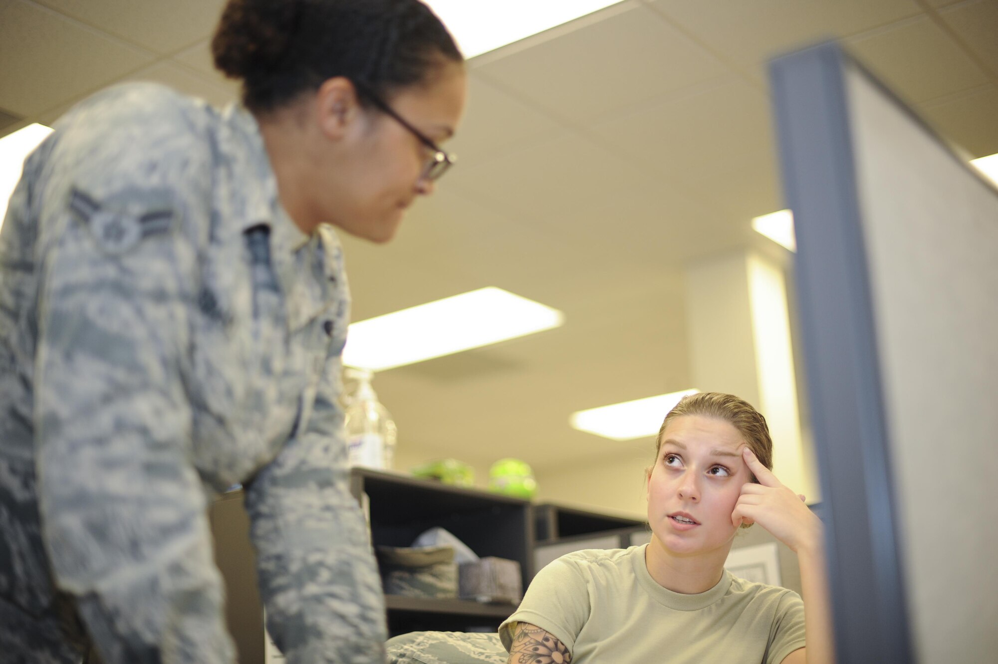 U.S. Air Force Airman 1st Class Joice Dominguez and Dejah Grant, 355th Logistics Readiness Squadron logistics planners, communicate on deployment details at Davis-Monthan Air Force Base, Ariz., Aug. 18, 2016. The logistics planners deploy Airmen in support of five combatant commands. (U.S. Air Force photo by Airman 1st Class Mya M. Crosby)