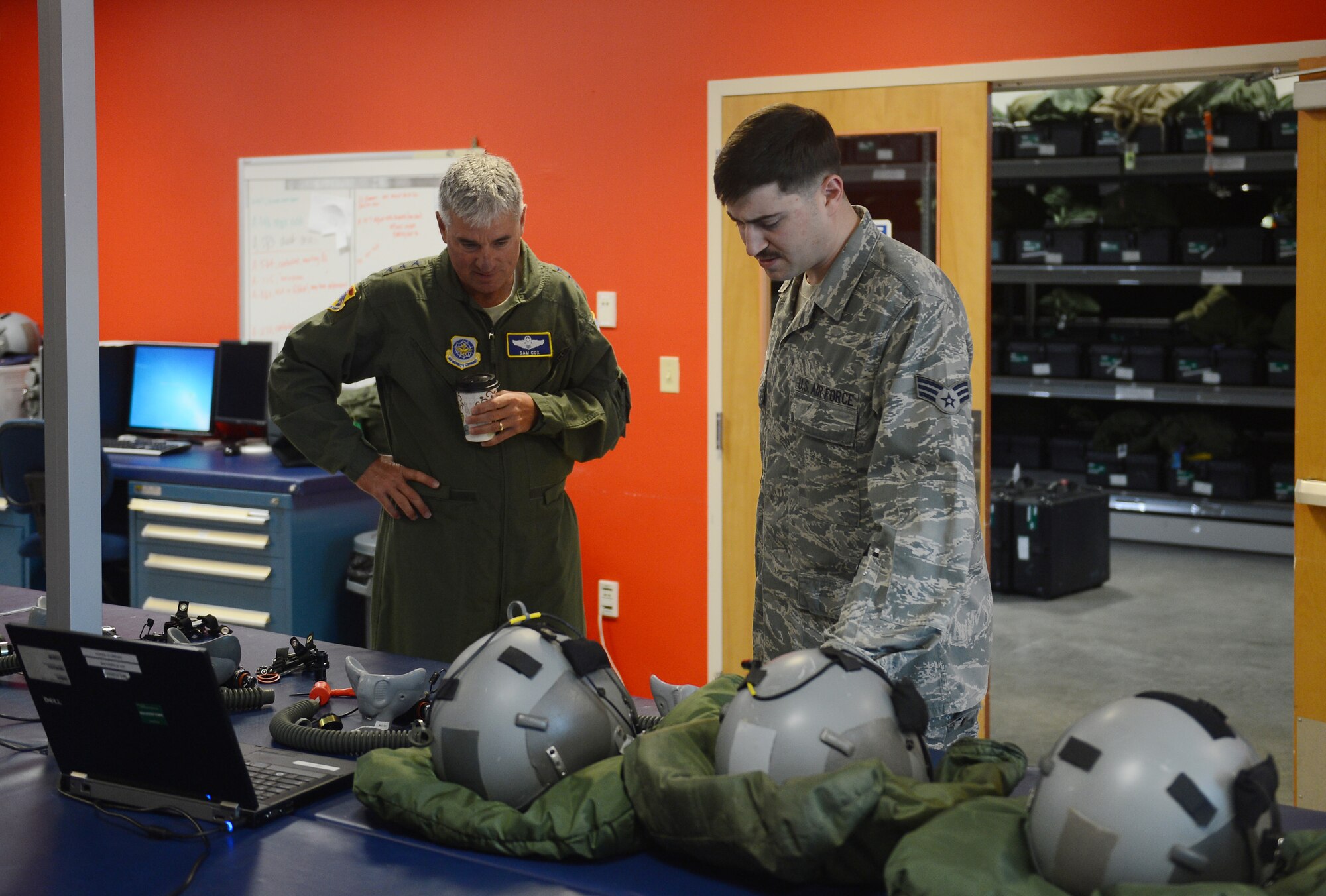 Senior Airman Steven Stork (right), 62nd Operation Support Squadron aircrew flight equipment technician, briefs Lt. Gen. Sam Cox (left), 18th Air Force commander, during his visit at Joint Base Lewis-McChord, Wash., Aug. 17, 2016. During his visit, Cox toured various organizations on McChord Field and was briefed by Airmen on how they support the mission. (U.S. Air Force photo/Senior Airman Divine Cox) 