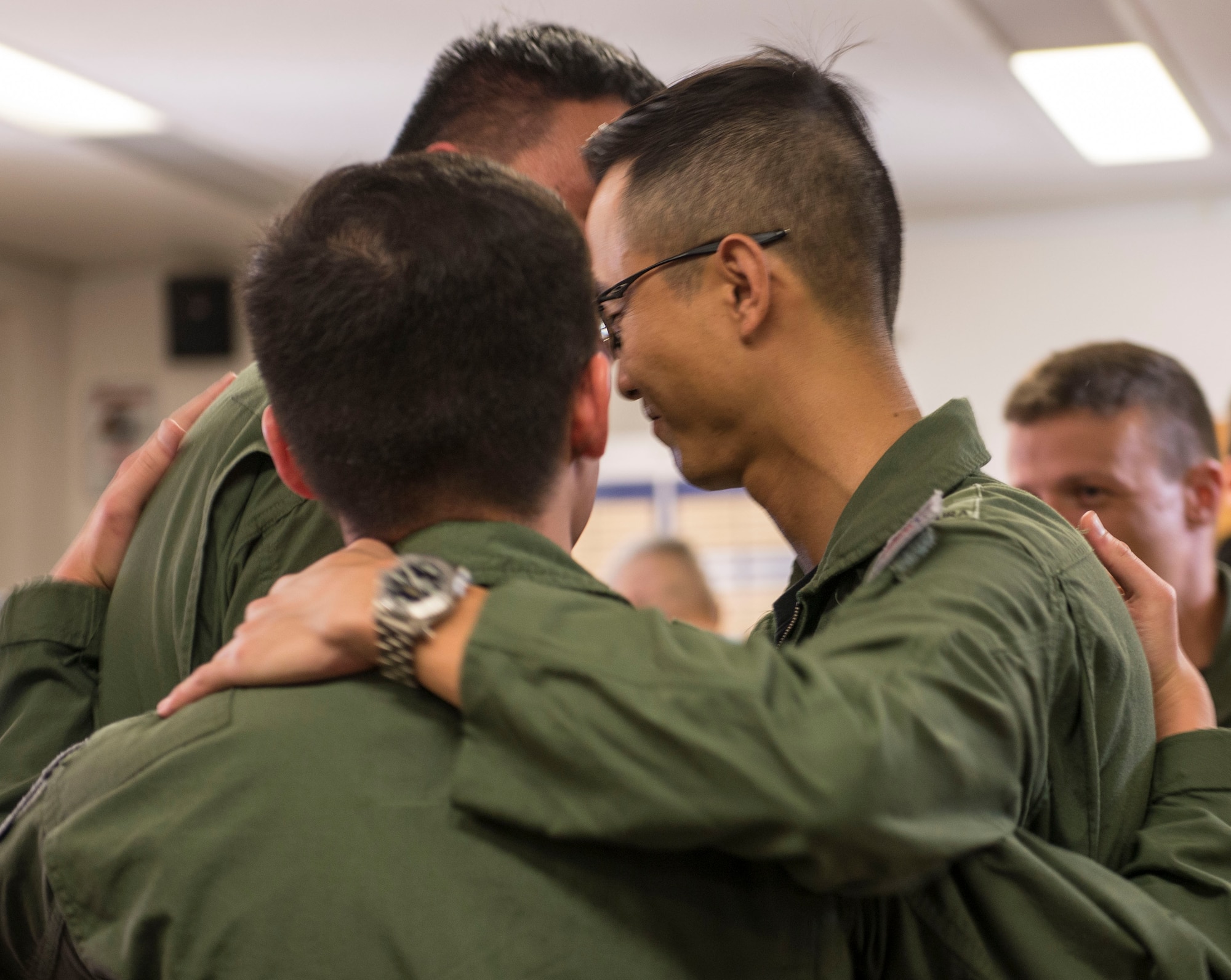 The Republic of Singapore Air Force Capts. Chia Chi Yu, and Alex Ong, 428th Fighter Squadron weapons systems officers, and Maj. Wang Kee Yong, 428th FS F-15SG pilot, hug after a patching ceremony July 22, 2016 at Mountain Home Air Force Base, Idaho. The three are the first to graduate the RSAF Fighter Weapons Instructor Course, modeled after the U.S. Air Force Fighter Weapons School program. (U.S. Air Force photo by Senior Airman Lauren-Taylor Levin/Released)