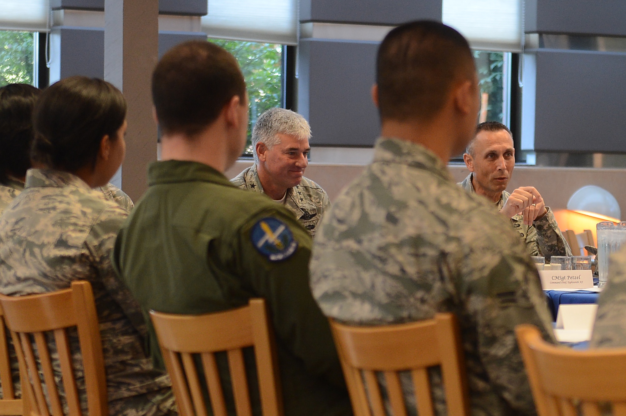 Lt. Gen. Sam Cox (right center), 18th Air Force commander, and Chief Master Sgt. Todd Pezel (right), 18th AF command chief, meet with Team McChord Airmen during their visit at Joint Base Lewis-McChord, Wash., Aug. 18, 2016. The Airmen were selected by their leadership and were afforded the opportunity to ask the general and chief any question they had in regards to the Air Force. (U.S. Air Force photo/Senior Airman Divine Cox) 