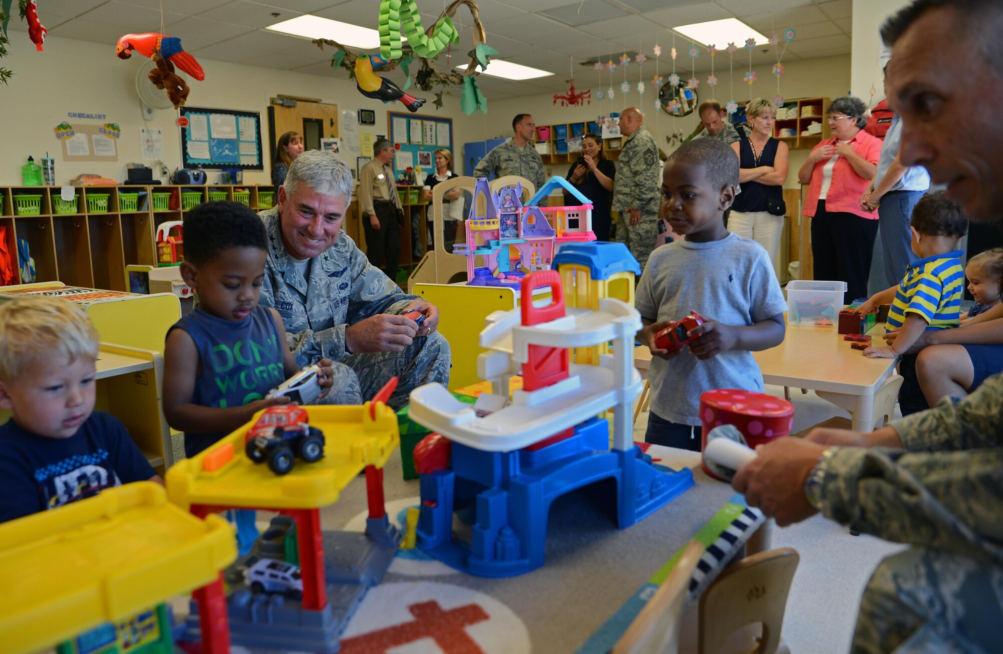 Lt. Gen. Sam Cox (left), 18th Air Force commander, and Chief Master Todd Petzel, 18th Air Force command chief, interact with children at the McChord Child Development Center Aug. 18, 2016, at Joint Base Lewis-McChord, Wash. Cox visited the CDC to learn more about the joint base led facility and to inform the staff of how valuable they are. The men and women who work at the CDC take care of our families, which significantly impacts the misison. (U.S. Air Force photo/Senior Airman Jacob Jimenez)  