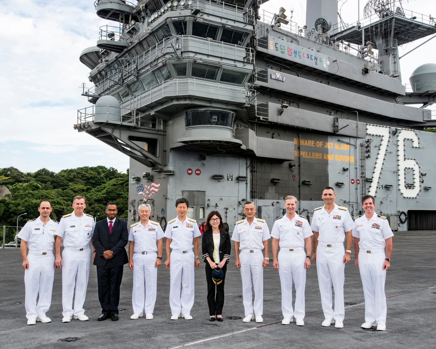 YOKOSUKA, Japan (Aug. 23, 2016) From left to right, Capt. Manny Pincon, Defense Attaché, United States Defense Attaché Office, Rear Adm. Charles Williams, Commander, Battle Force 7th fleet, Mr. Nick Larsen, Assistant Chief, Pol-Mil Dept. U.S. Embassy Tokyo, Vice Adm. Tetsuro Doshita, Commandant, Yokosuka District, Adm. Tomohisa Takei, Chief of Staff, Maritime Staff Office, Tomomi Inada, Defense Minister, Government of Japan, Vice Adm. Yasuhiro Shigeoka, Commander in Chief, Self Defense Fleet, Vice Adm. Joseph Aucoin, 7th Fleet, Rear Adm. Matt Carter, Naval Forces, Japan, and Capt. Buzz Donnelly, Commanding Officer, USS Ronald Reagan, pose for a photograph on the flight deck of the Navy’s only forward-deployed aircraft carrier USS Ronald Reagan (CVN 76). While on board, the defense minister and her accompanying group received a tour and brief about the mission of the forward-deployed naval forces. Japanese Minister of Defense Tomomi Inada’s visit aboard Ronald Reagan marks her first visit to U.S. forces in Japan since she took office. While on board, the defense minister and her accompanying group received a tour and brief about the mission of the forward-deployed naval forces. Ronald Reagan is forward deployed to Japan in support of security and stability in the Indo-Asia-Pacific region. (U.S. Navy photo by MC3 Ryan McFarlane)