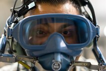 Senior Airman Kenny Batallas, 374th Operation Support Squadron aircrew flight equipment, performs a quick-don operations check using a scot tester during Red Flag-Alaska at Joint Base Elmendorf-Richardson, Alaska, Aug. 20, 2016. Red Flag provides the opportunity for various units and career field to work together to in a simulated wartime environment. (U.S. Air Force photo by Staff Sgt. Michael Smith/Released)
