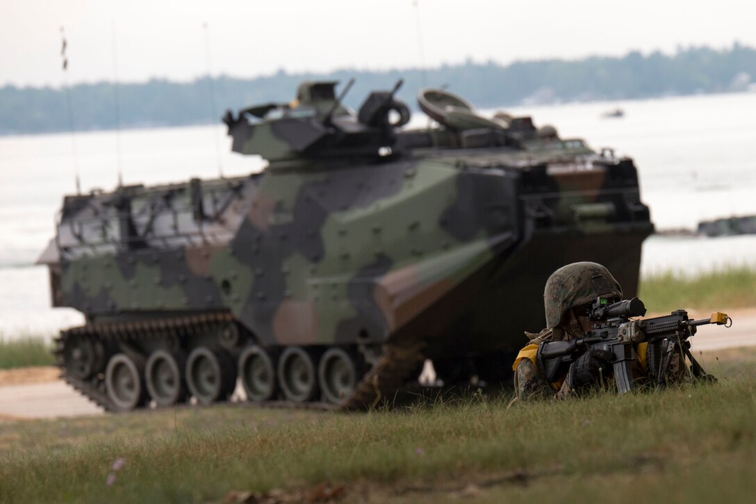 CAMP GRAYLING, Mich. -- A Marine with 4th Assault Amphibian Battalion, 4th Marine Division, Marine Forces Reserve, provides security for his amphibious assault vehicle at Camp Grayling Joint Maneuver Training Center, Mich., Aug. 17, 2016. The exercise also included infantry training techniques and military operations in urban terrain.  Exercise Northern Strike Northern Strike 16 is a National Guard Bureau-sponsored exercise uniting approximately 5,000 Army, Air Force, Marine, and Special Forces service members from 20 states and three coalition countries. The exercise strives to provide accessible, readiness-building opportunities for military units from all service branches to achieve and sustain proficiency in conducting mission command, air, sea, and ground maneuver integration, and the synchronization of fires in a joint, multinational, decisive action environment. (U.S. Marine Corps photo by Cpl. Devan Alonzo Barnett/Released)